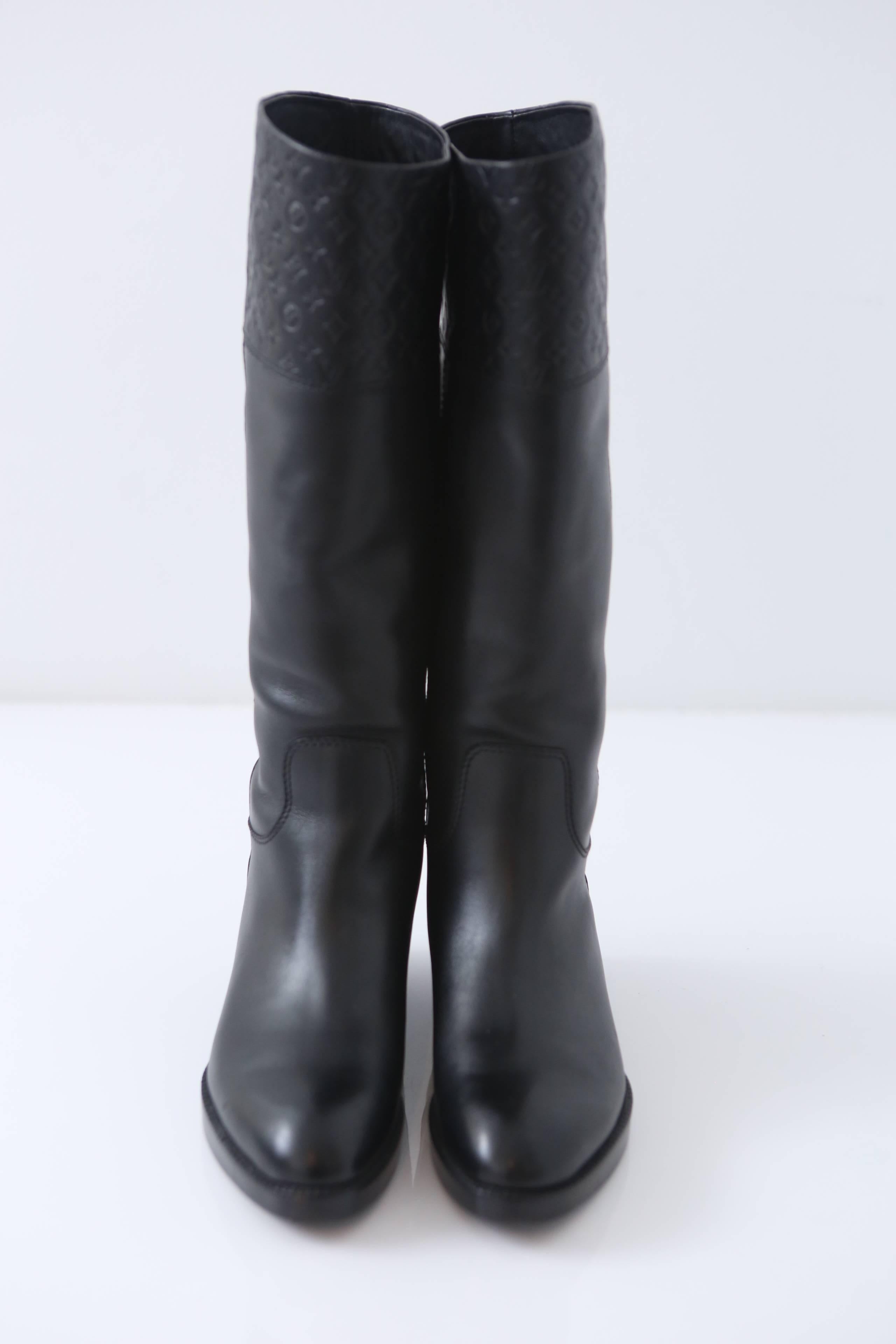 Louis Vuitton riding style boots with Embossed monogram pattern at top. 