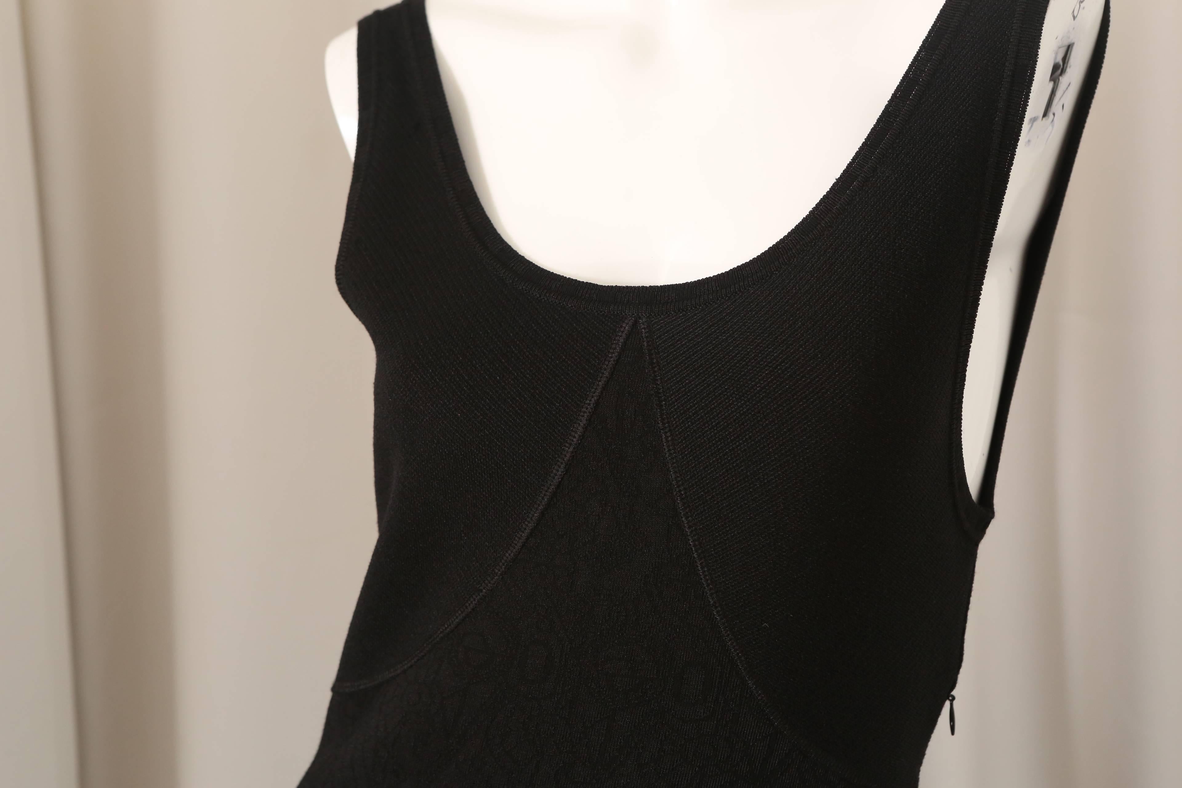 Zac Posen sleeveless black textured dress with flare bottom.