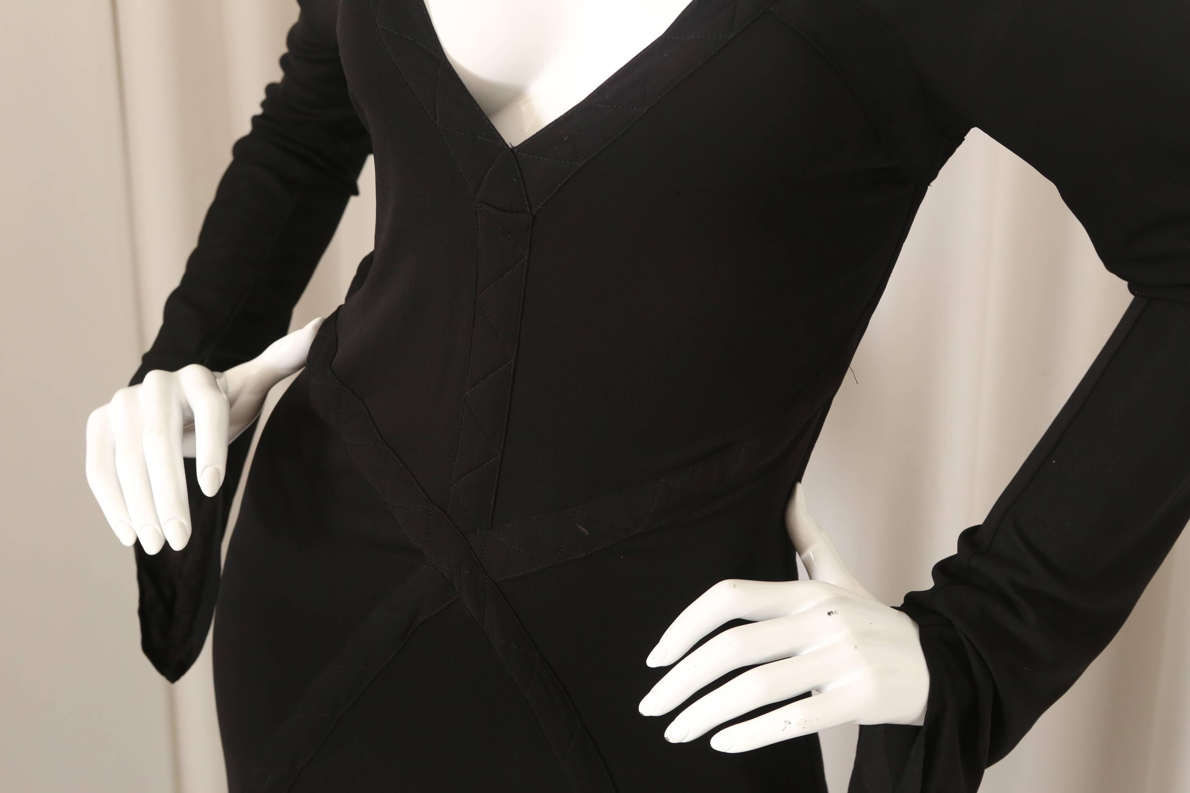 YSL black dress with bell sleeves with open back, stitching detail, v-neck and open back.

