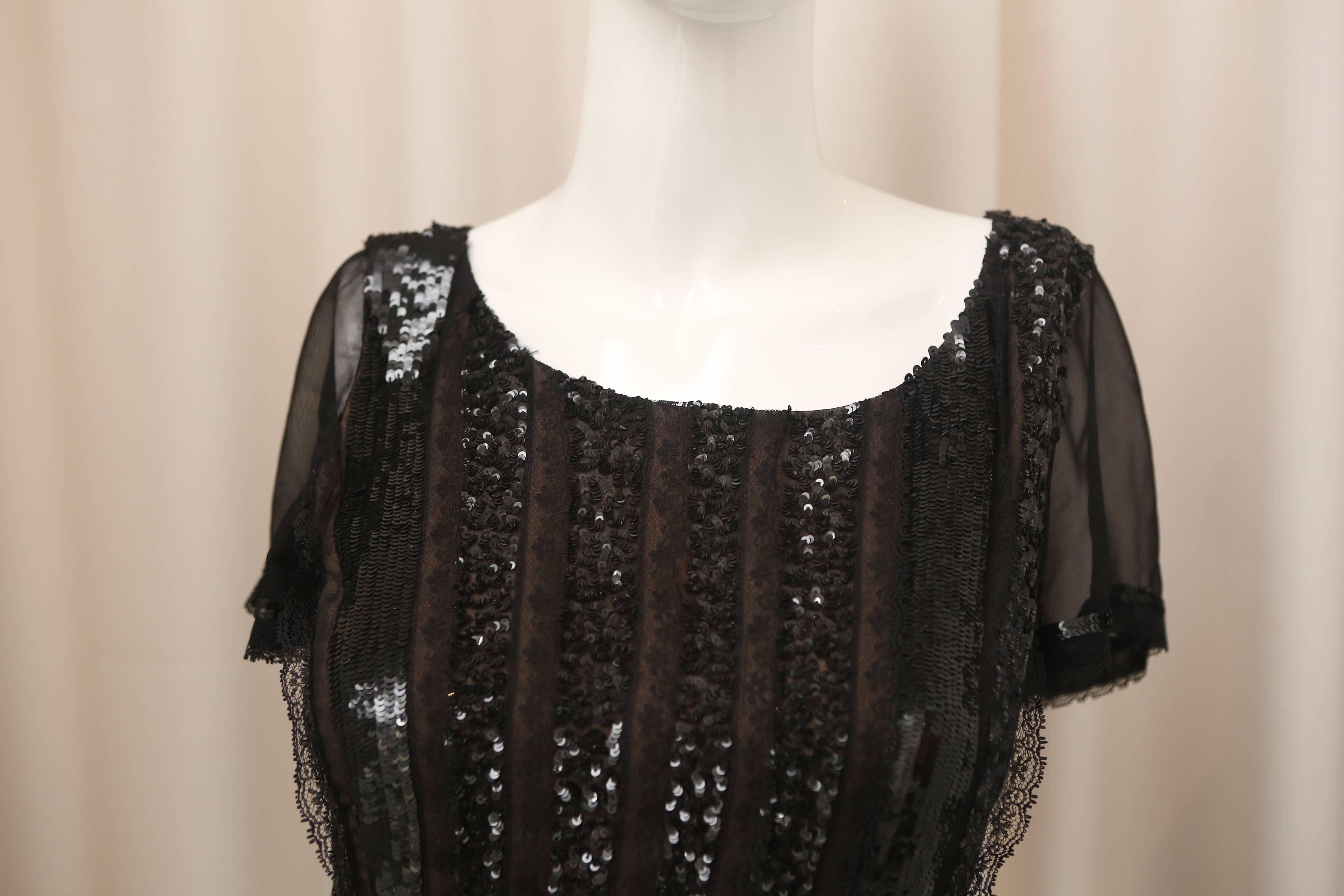 Oscar de la Renta short sleeve black silk dress with sequin panels, lace detailing with nude lining.  