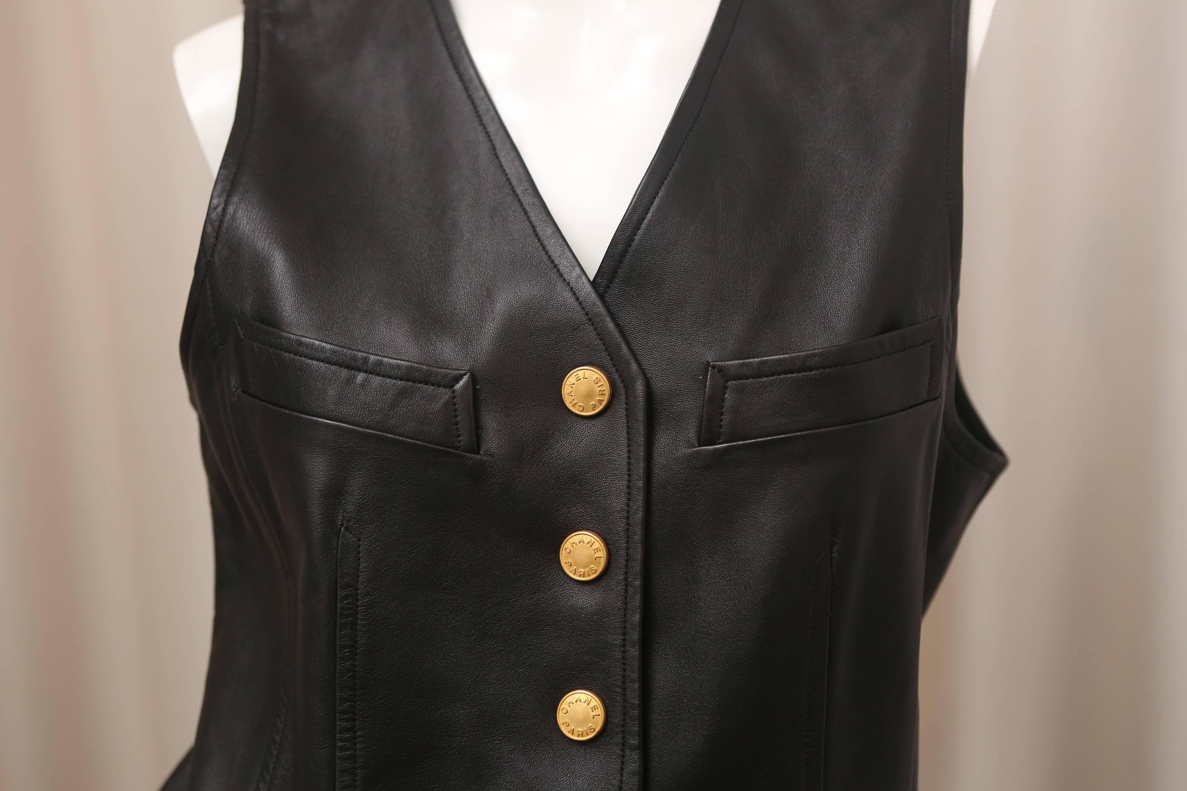 1993 Chanel sleeveless leather vest with gold snaps and adjustable built in belt in the back.  

From collection 93A.