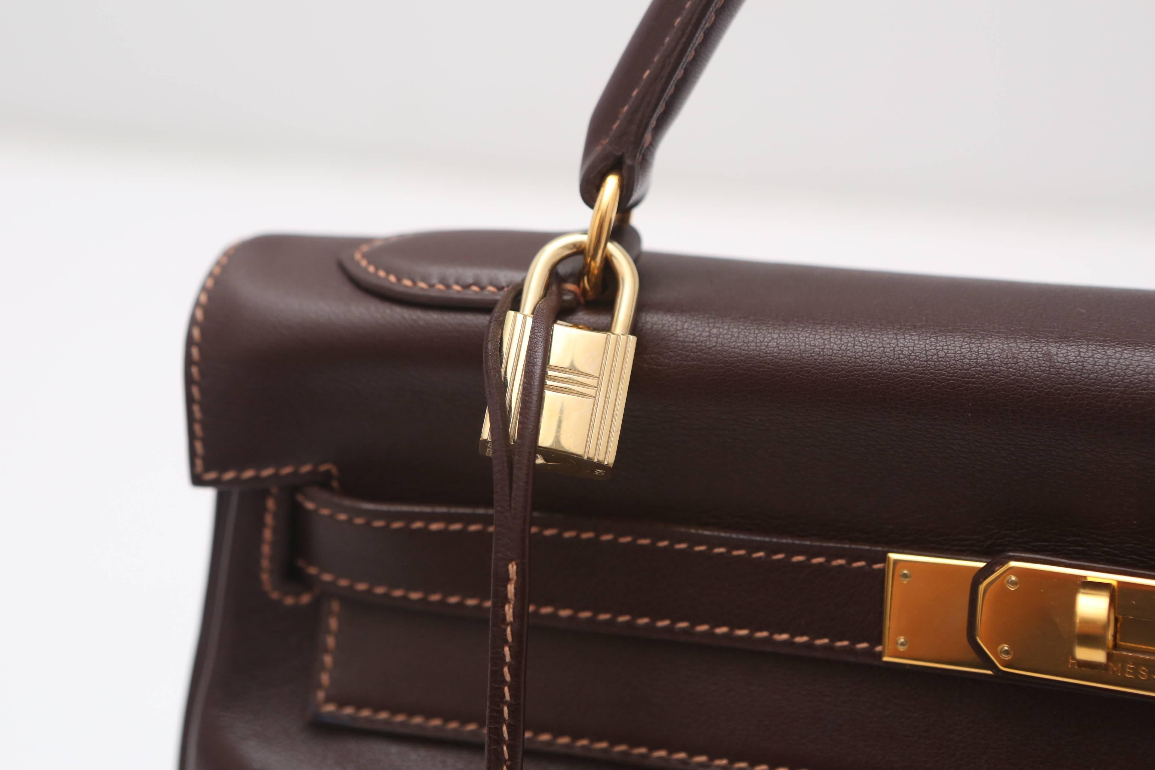 Hermes brown leather "Kelly" handbag with Gold HW.  Letter stamp 'X', Hermes lock and keys, and shoulder strap.  

*Slight wear on edges