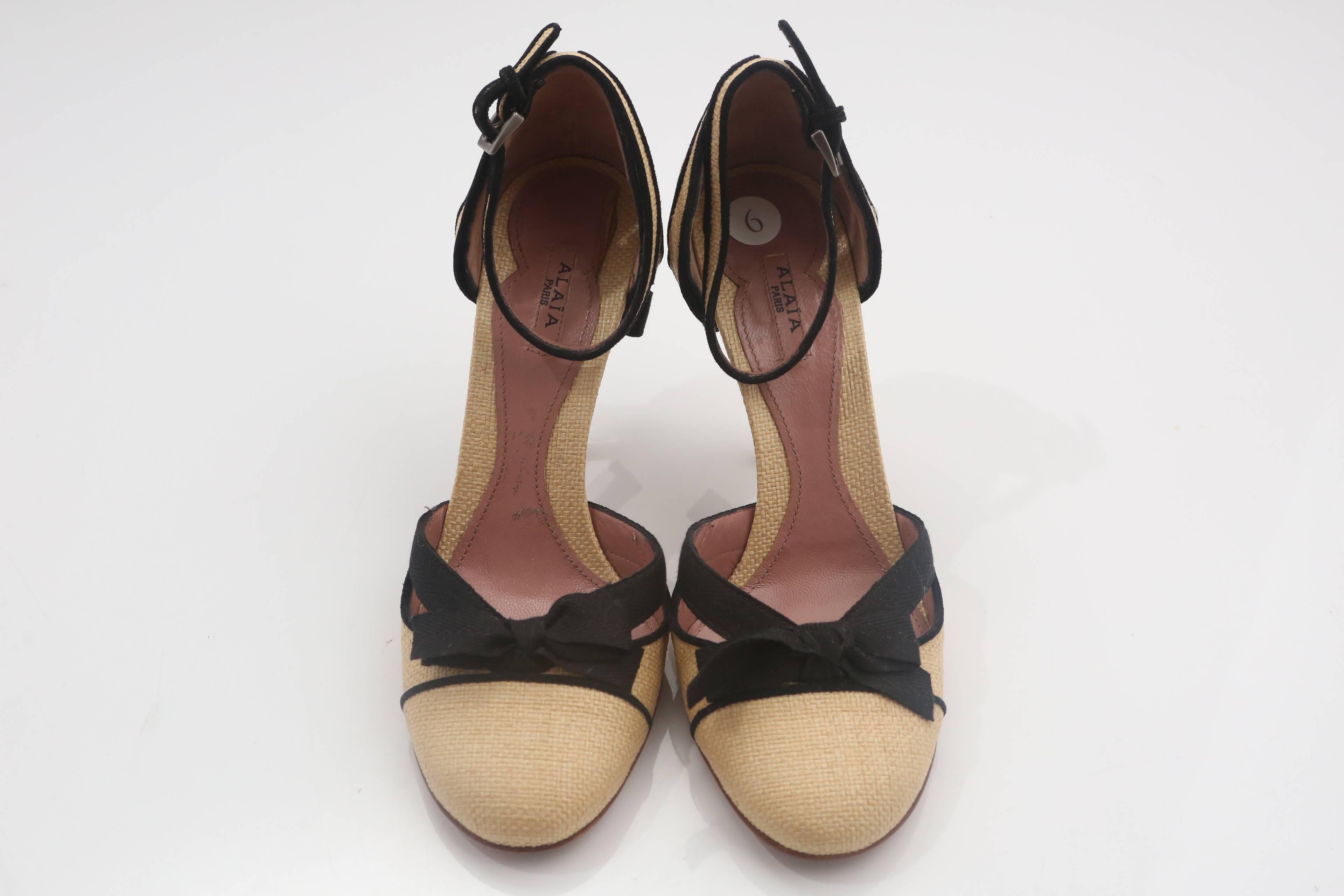 Alaia Linen and Black MaryJane Shoes with Bow bows at front and heel. Shoe features black piping and ankle strap closure.  