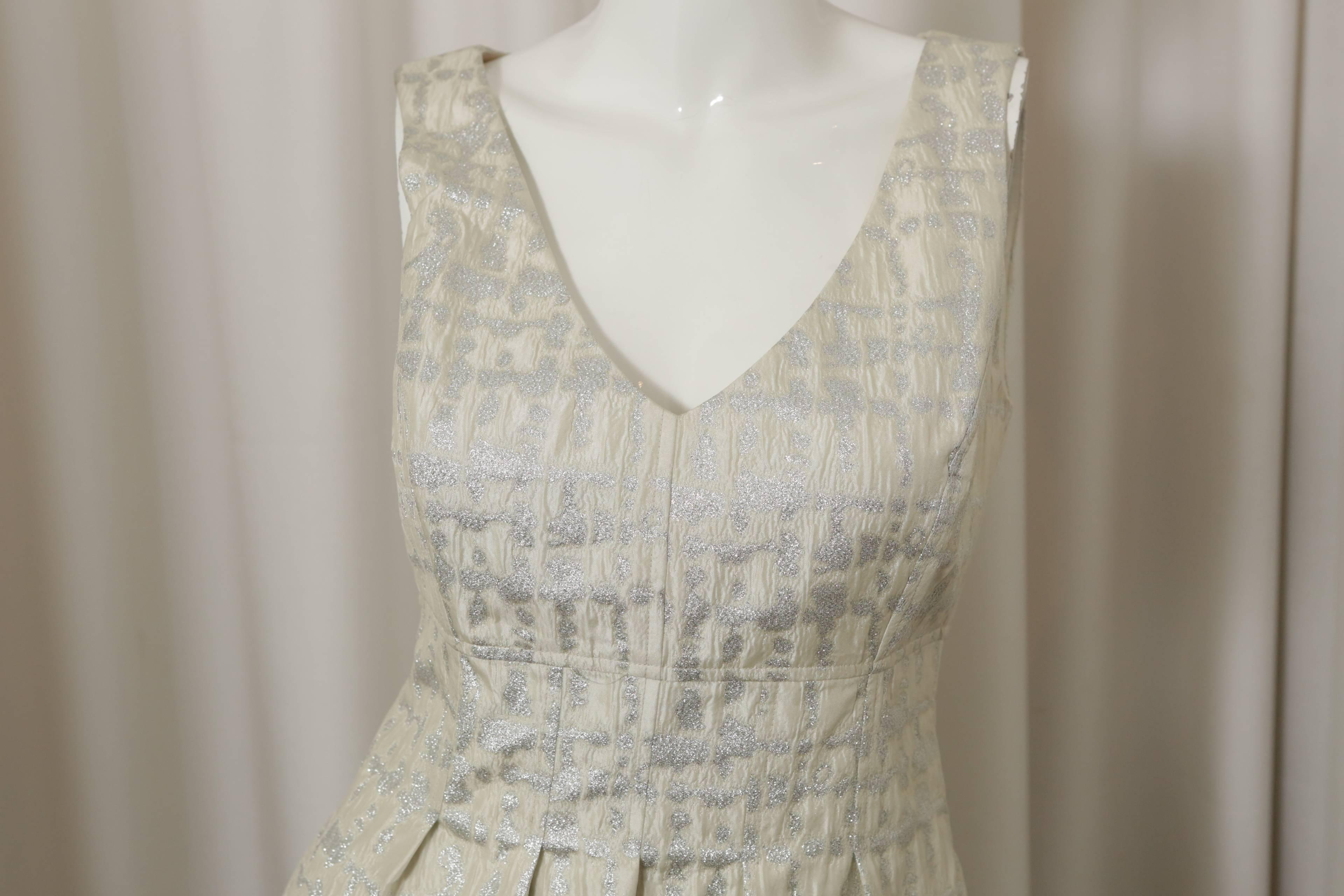 Lela Rose s/l ivory/metalic dress w/ pleating at waist & back zipper.