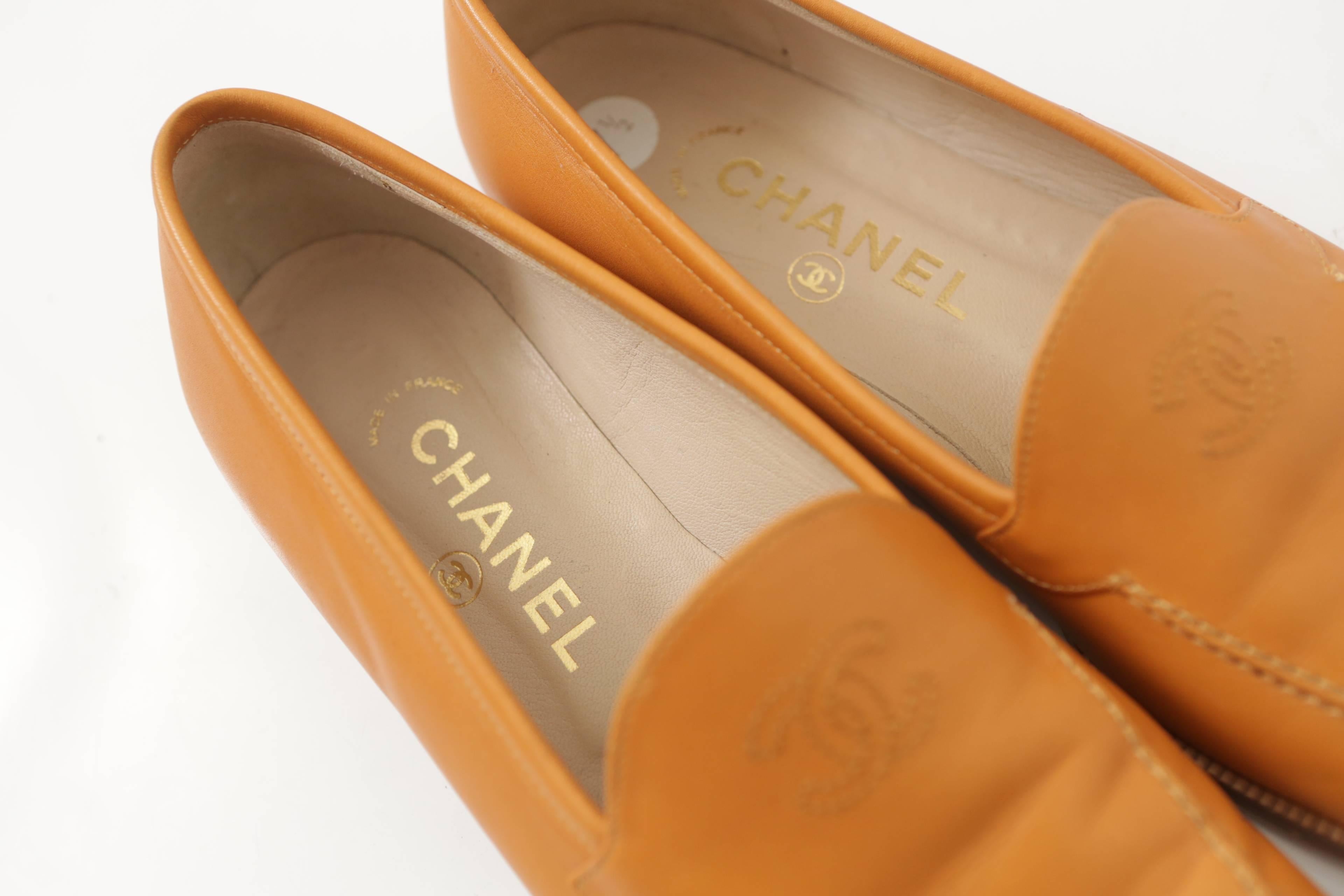 Chanel tan leather loafers w/ 'CC' logo on top.
