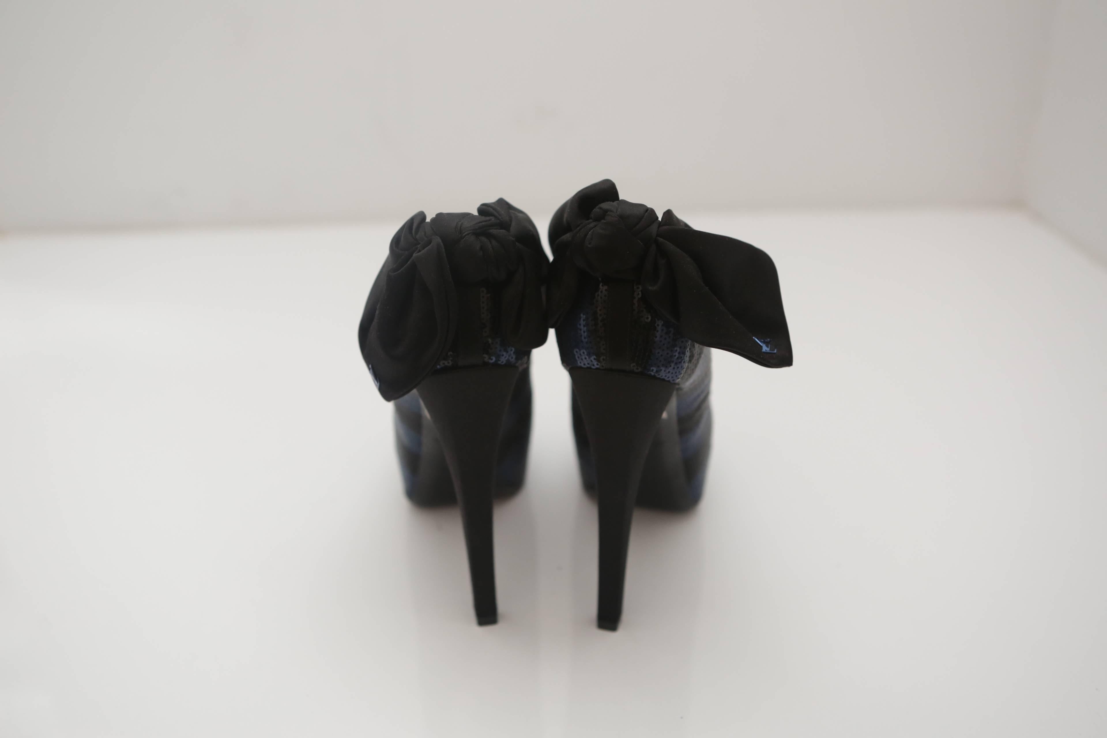 Louis Vuitton 6" peep-toe platform sequin pumps with black bow with "LV" monogram.