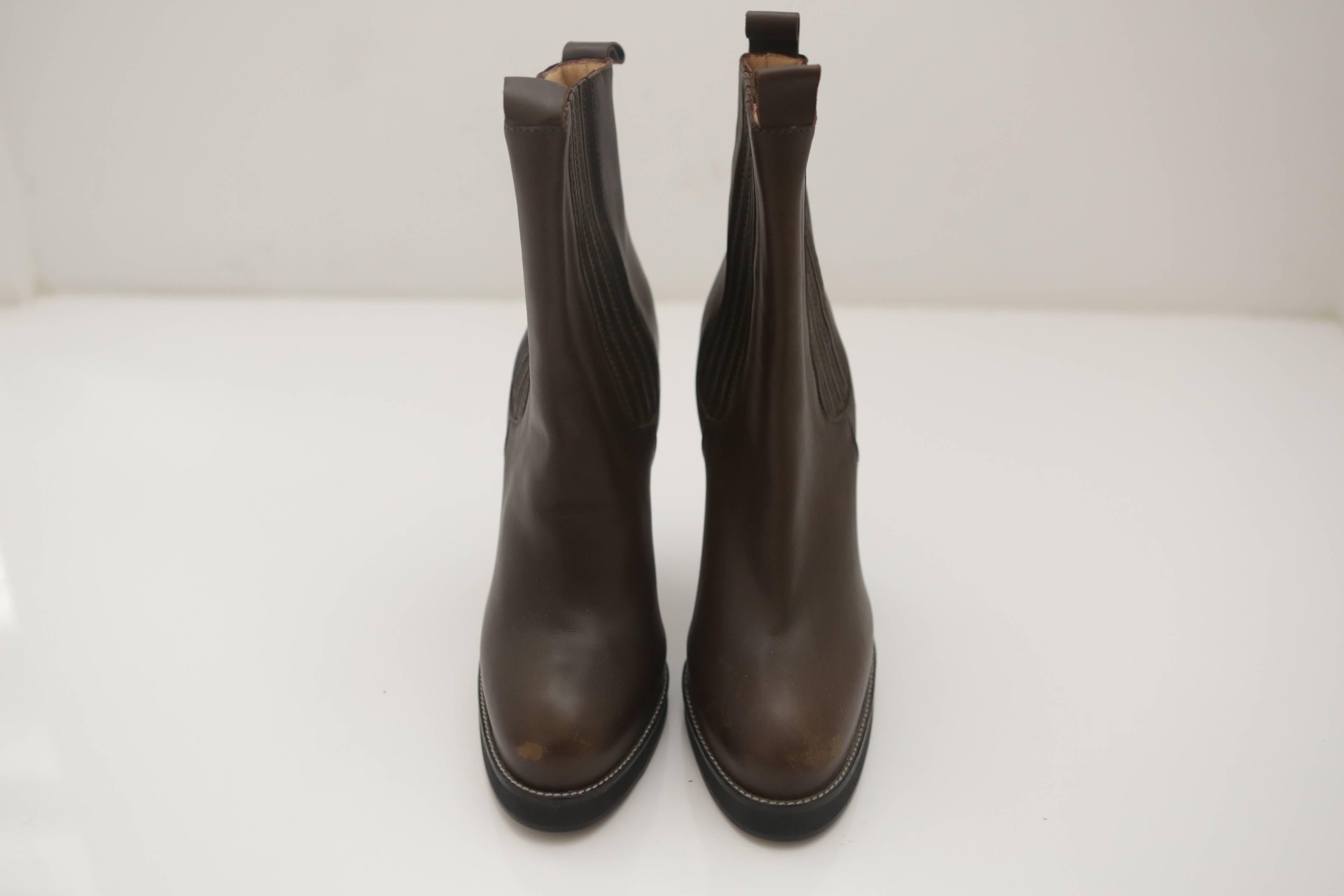 Balenciaga Ankle Boots with double pull strap at front and back in brown leather. Features detailed U-paneled stitching in tunnel tread on a stacked 5