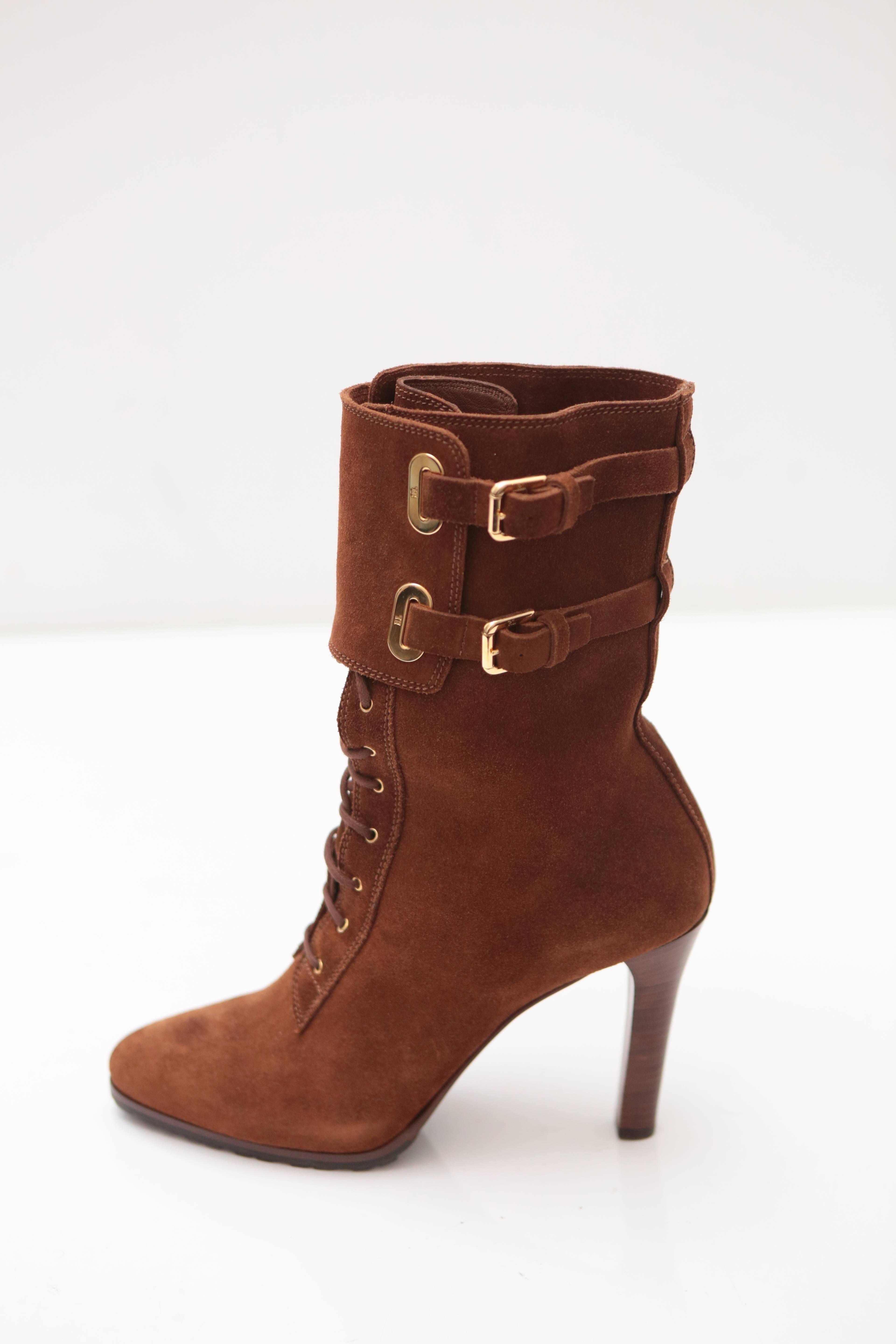 Double Buckle Cuff overlay with Gold Hardware adorns this lace-up suede ankle boot with rubber sole on stacked heel. The perfect cozy feel for a winter boot from Ralph Lauren.