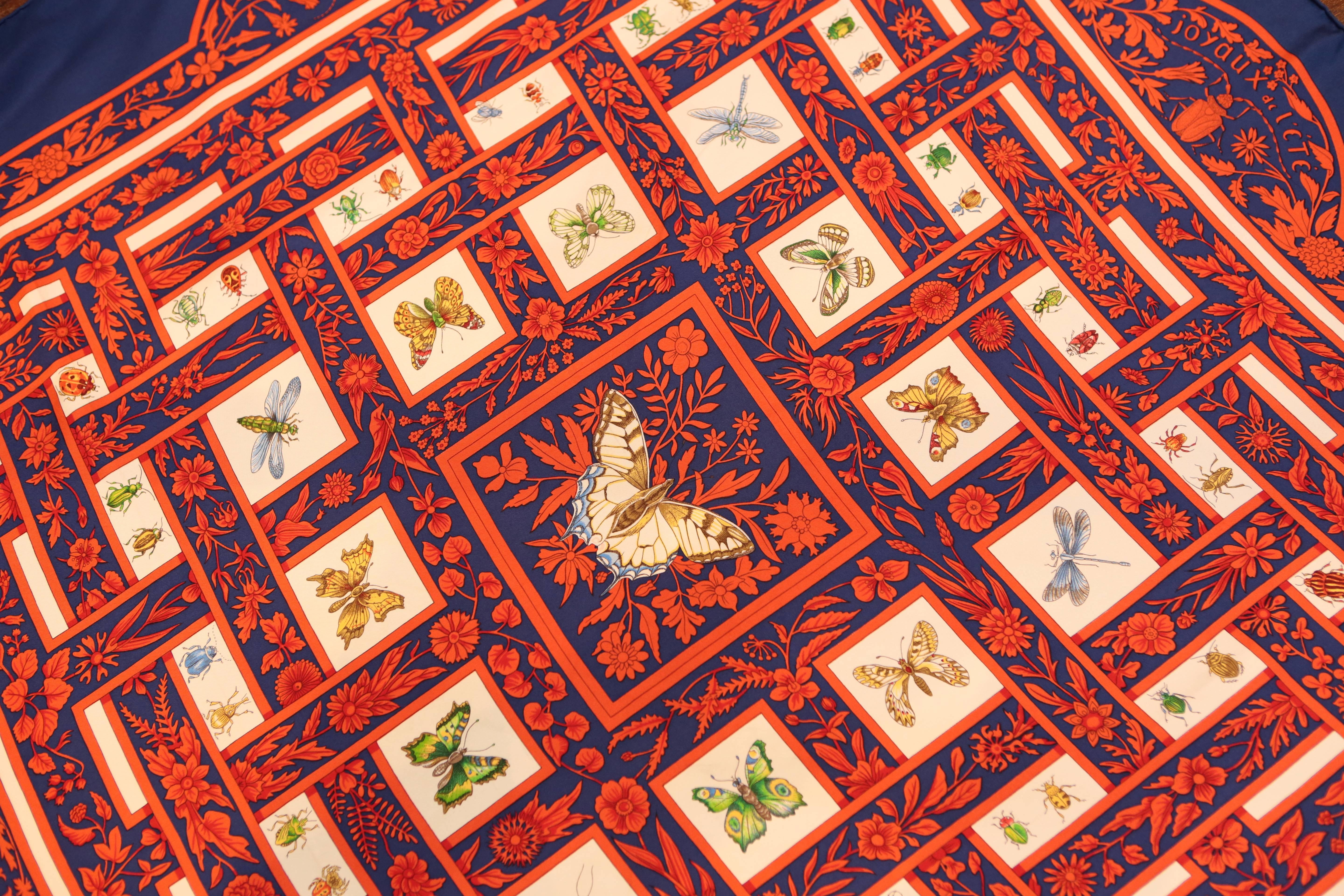 Antoine De Jacquelot design of ornate butterflies on a deep navy background encompassed by red florals.