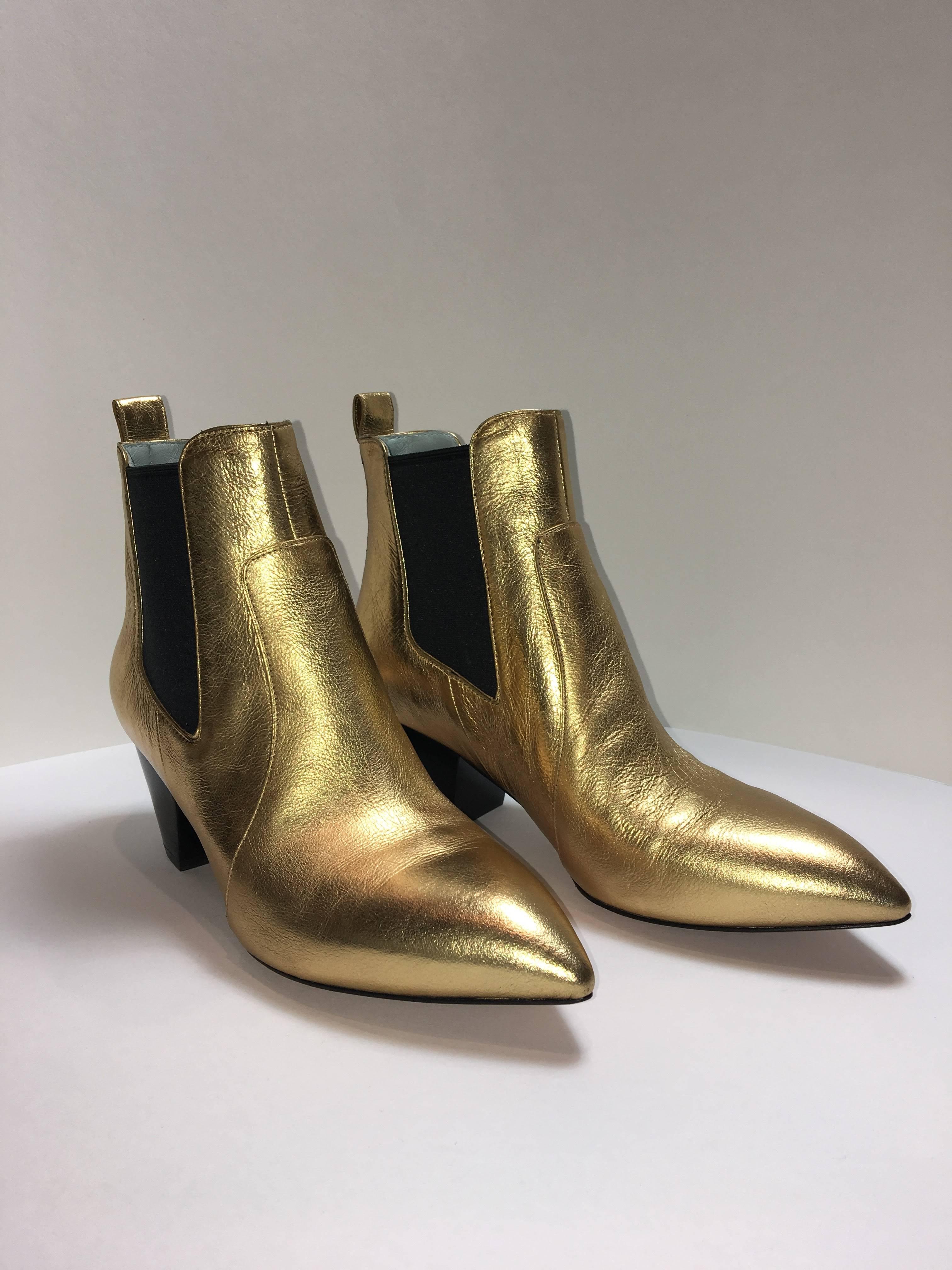 Golden Leather Bootie with contrasting black fabric at ankles. Easy to slip on with additional tab at ankle. Pointed toe and small heel.