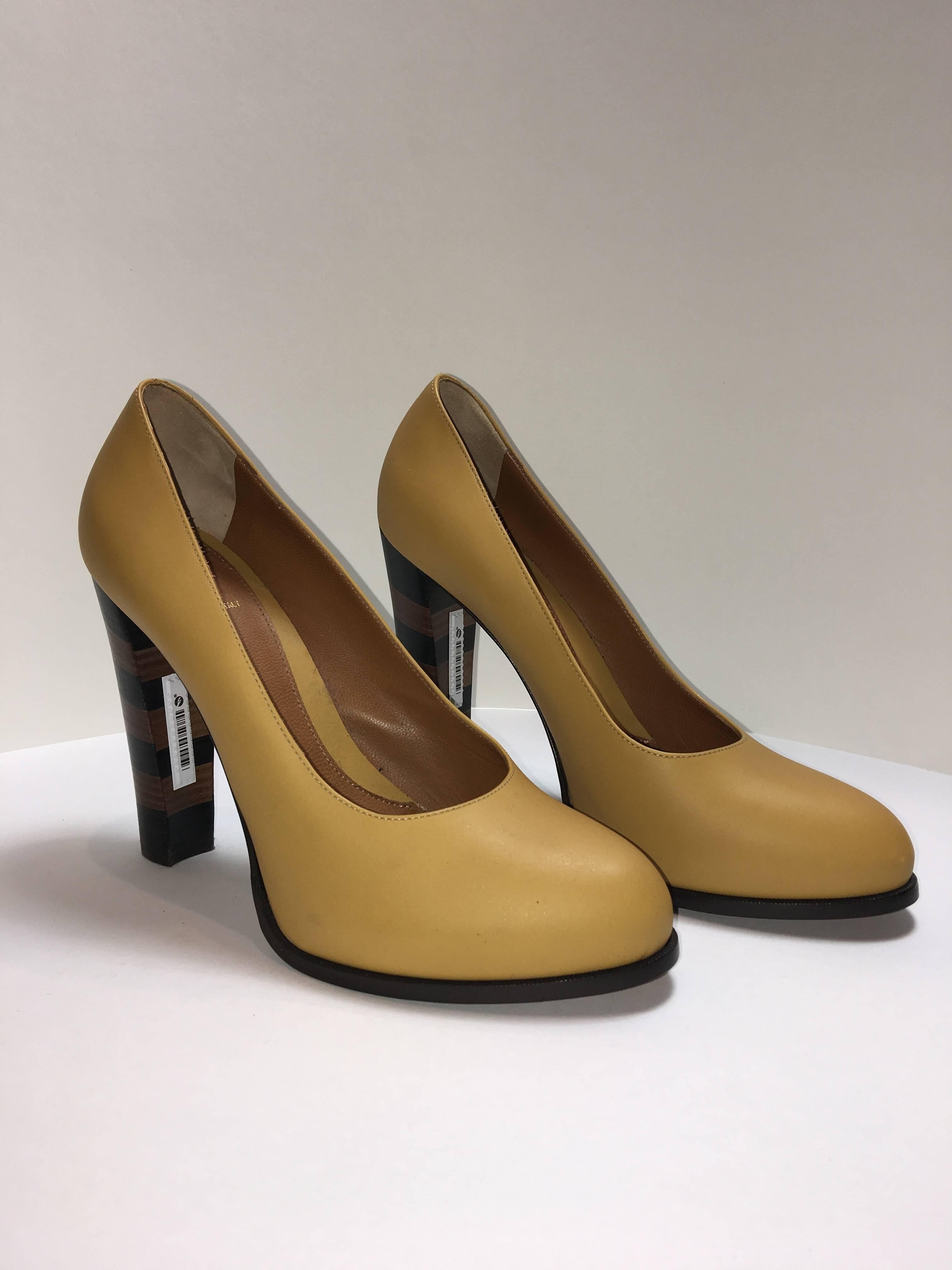 Fendi round toe pumps. Striped blocked heel with alternating brown and dark brown color blocking. Very light wear. 