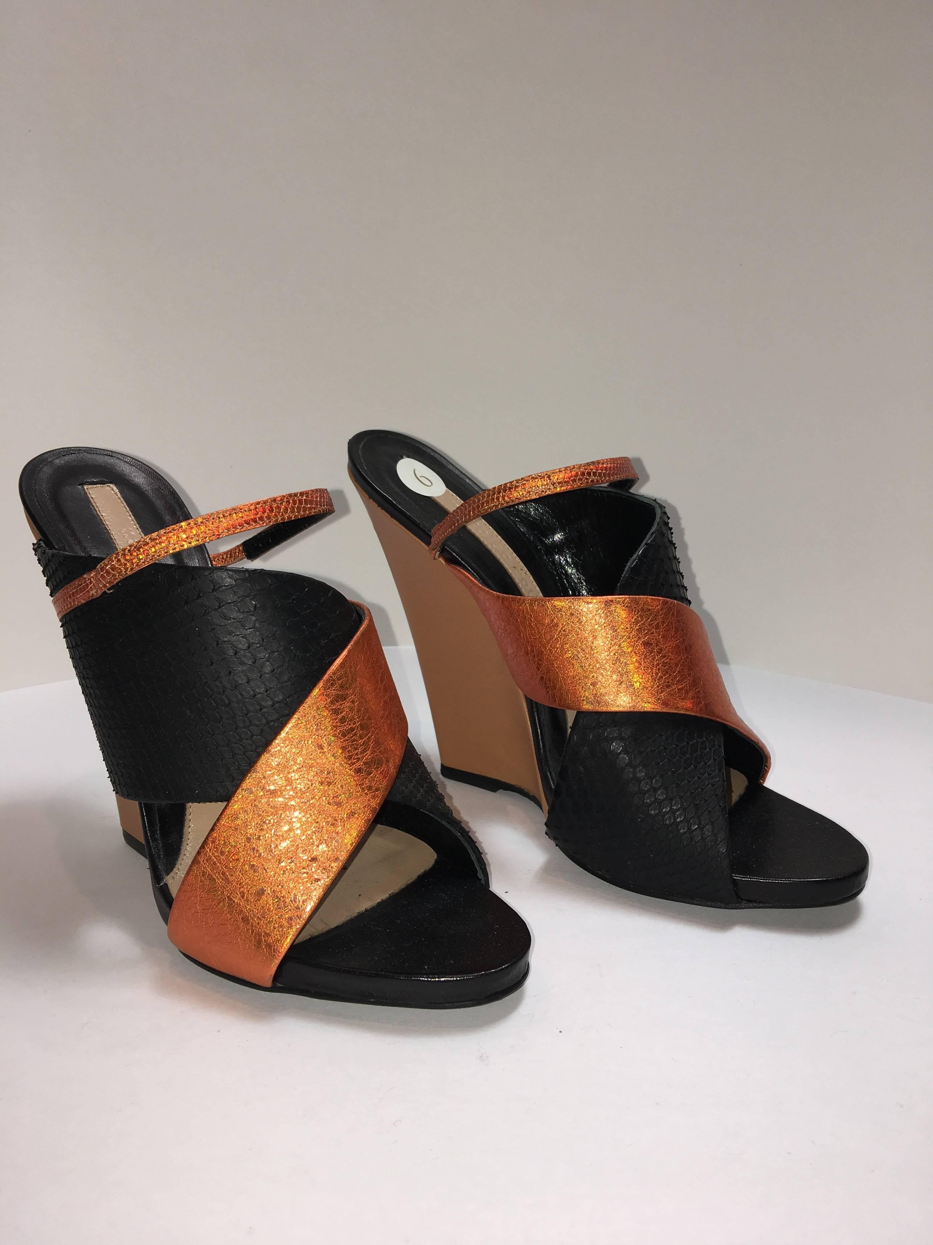 Criss-Cross strap wedges with contrasting metallic and snake print design. Two thick straps with a complimenting third narrow strap. 