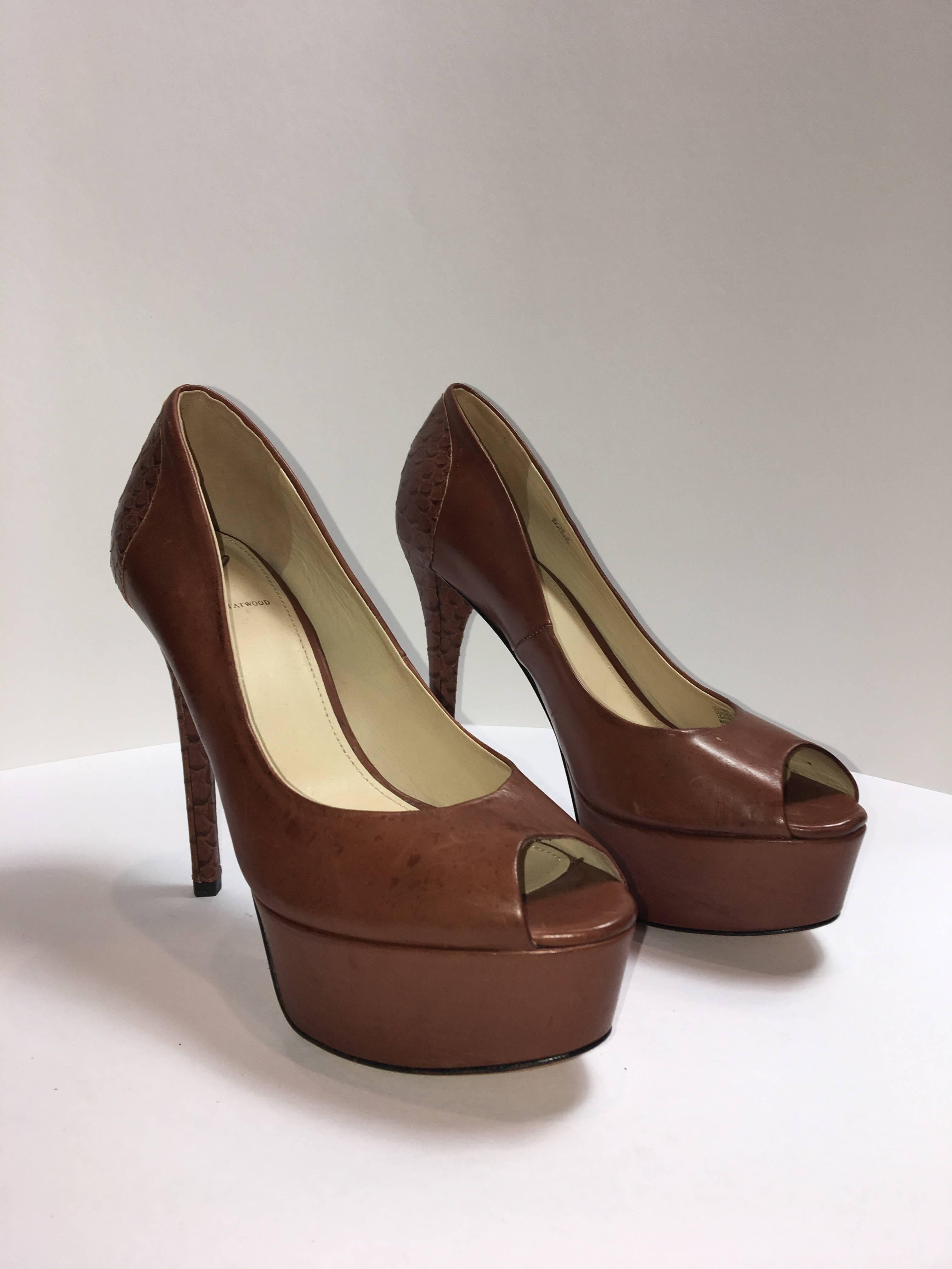 Brian Atwood Tan Leather peep toe pumps with snake scale heel. 