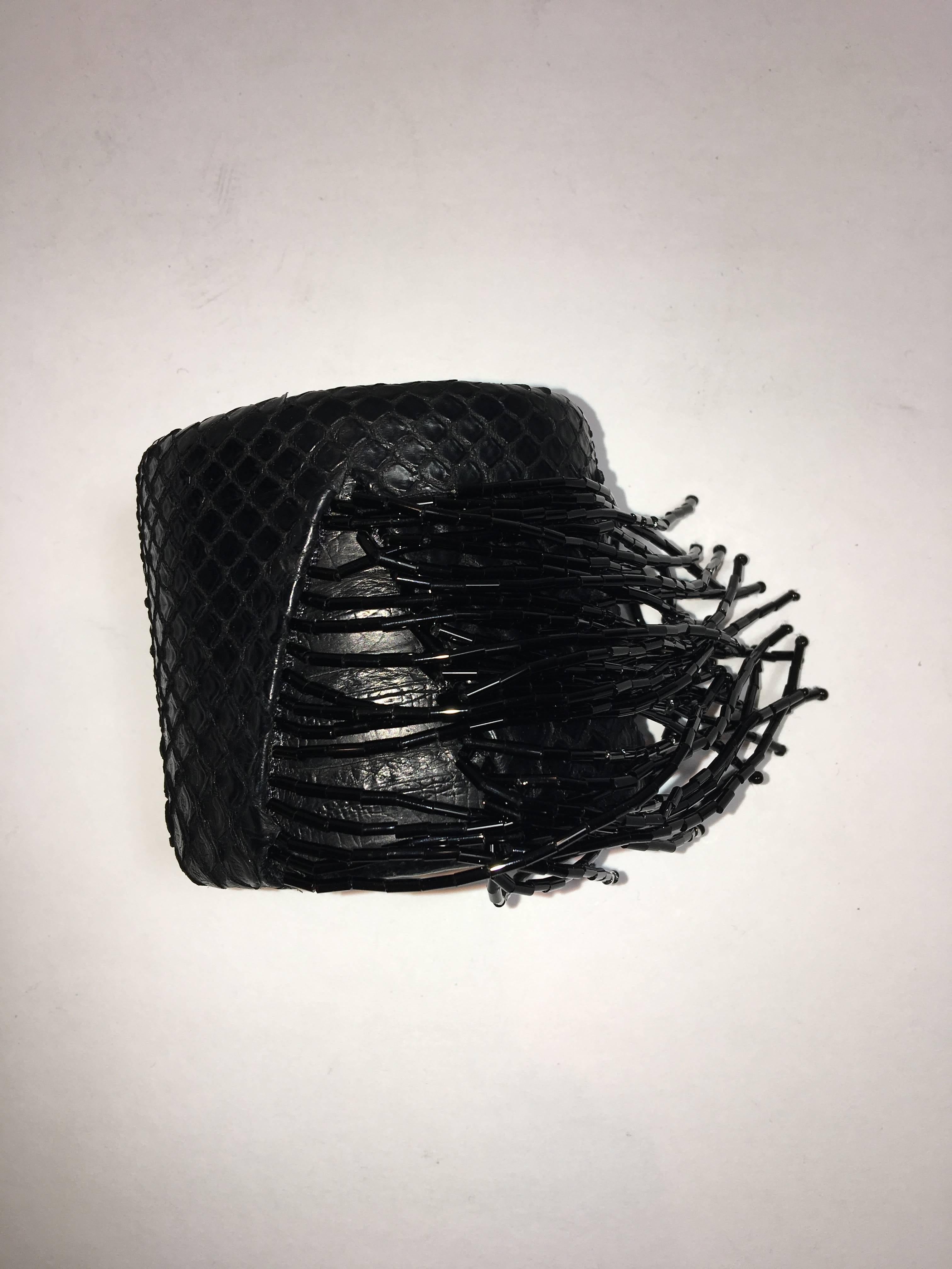 Snakeskin cuff with black tassel beading.