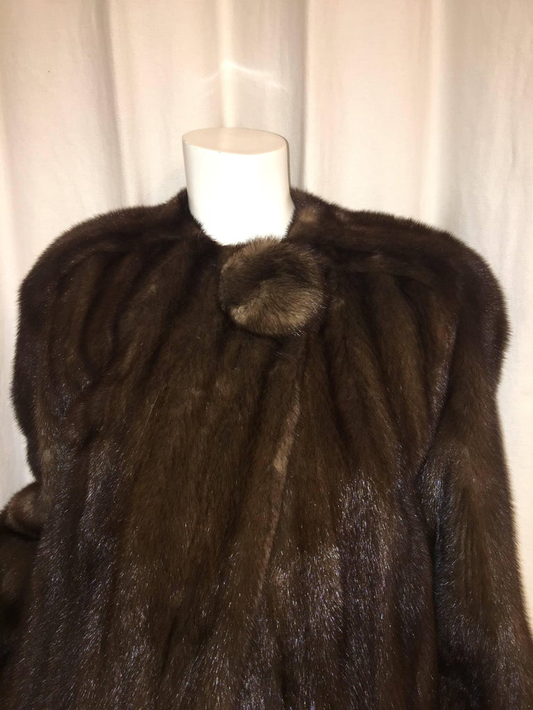 Full Length Mink Coat in Brown with Single Button

No specific size on a tag for this coat, but here are a few measurements:
Shoulder to shoulder: 21.5