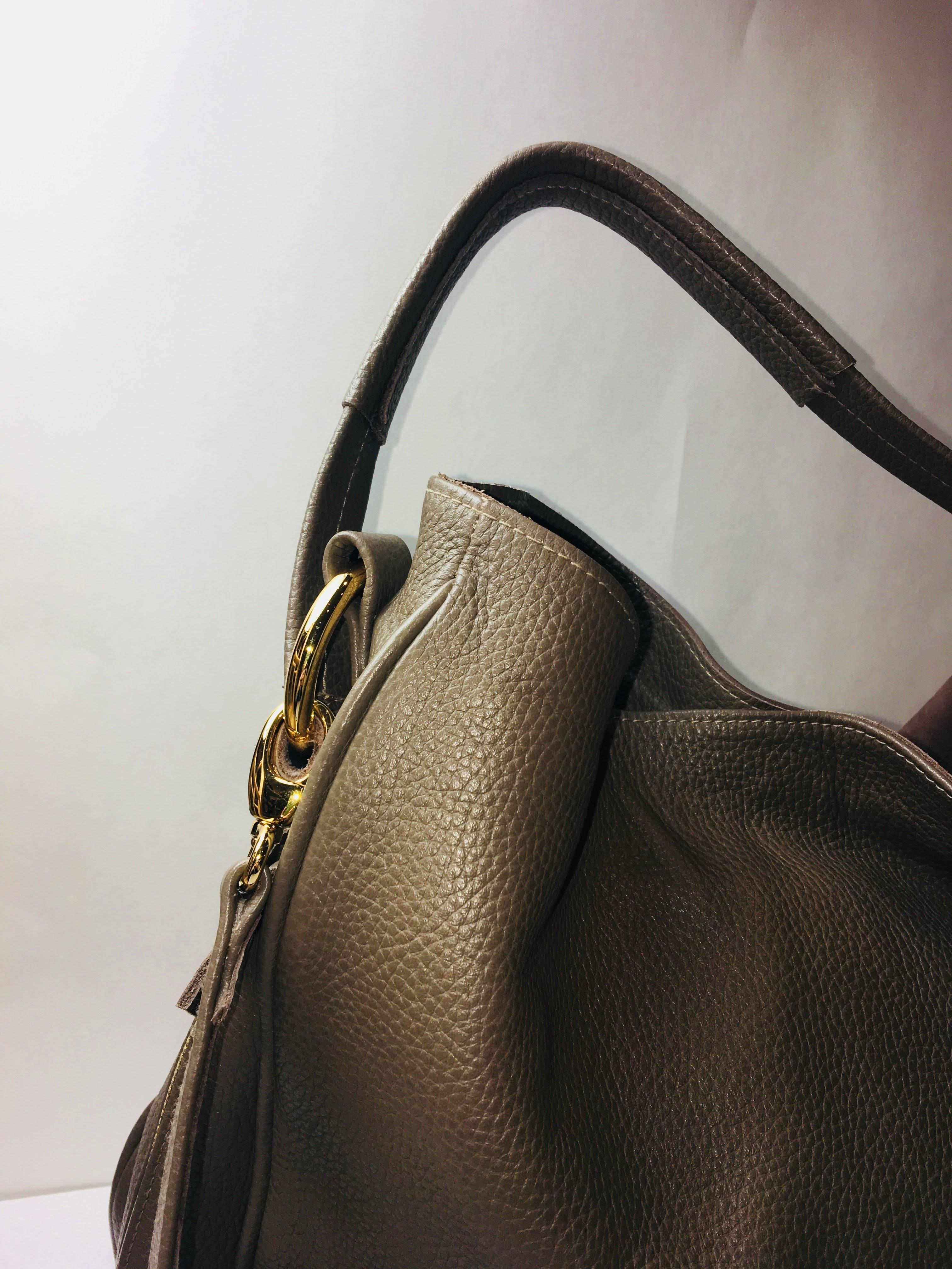 Laggo Suede Front Single Handle Top Saddle Bag with Zipper Detail and Gold Hardware.
