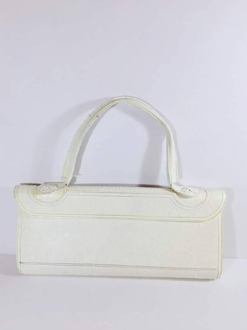 Fendi Floral Embossed Leather Frame Bag with Single Shoulder Strap and Magnetic Closure.