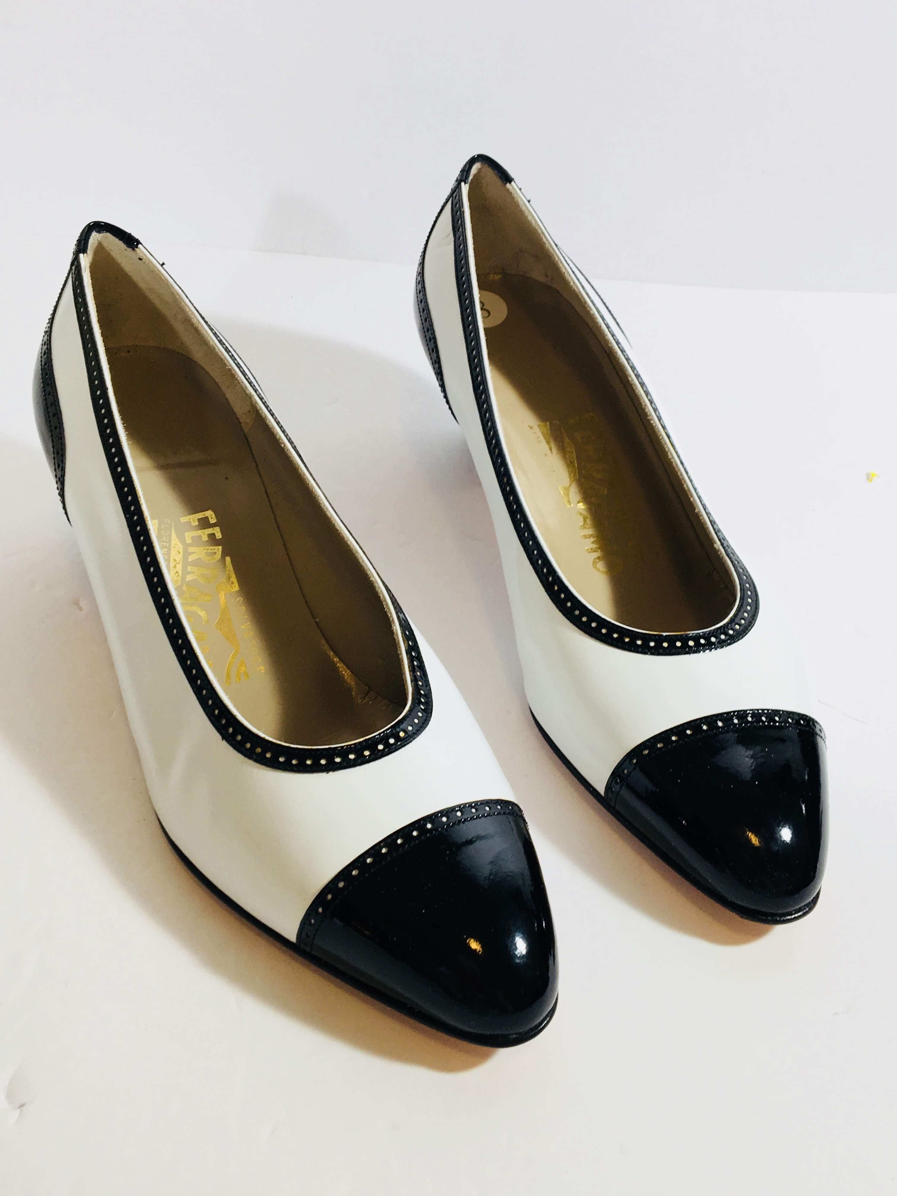 Salvatore Ferragamo Madison Pumps in Black and White Patent Leather with Round Toe and Small Block Heel.