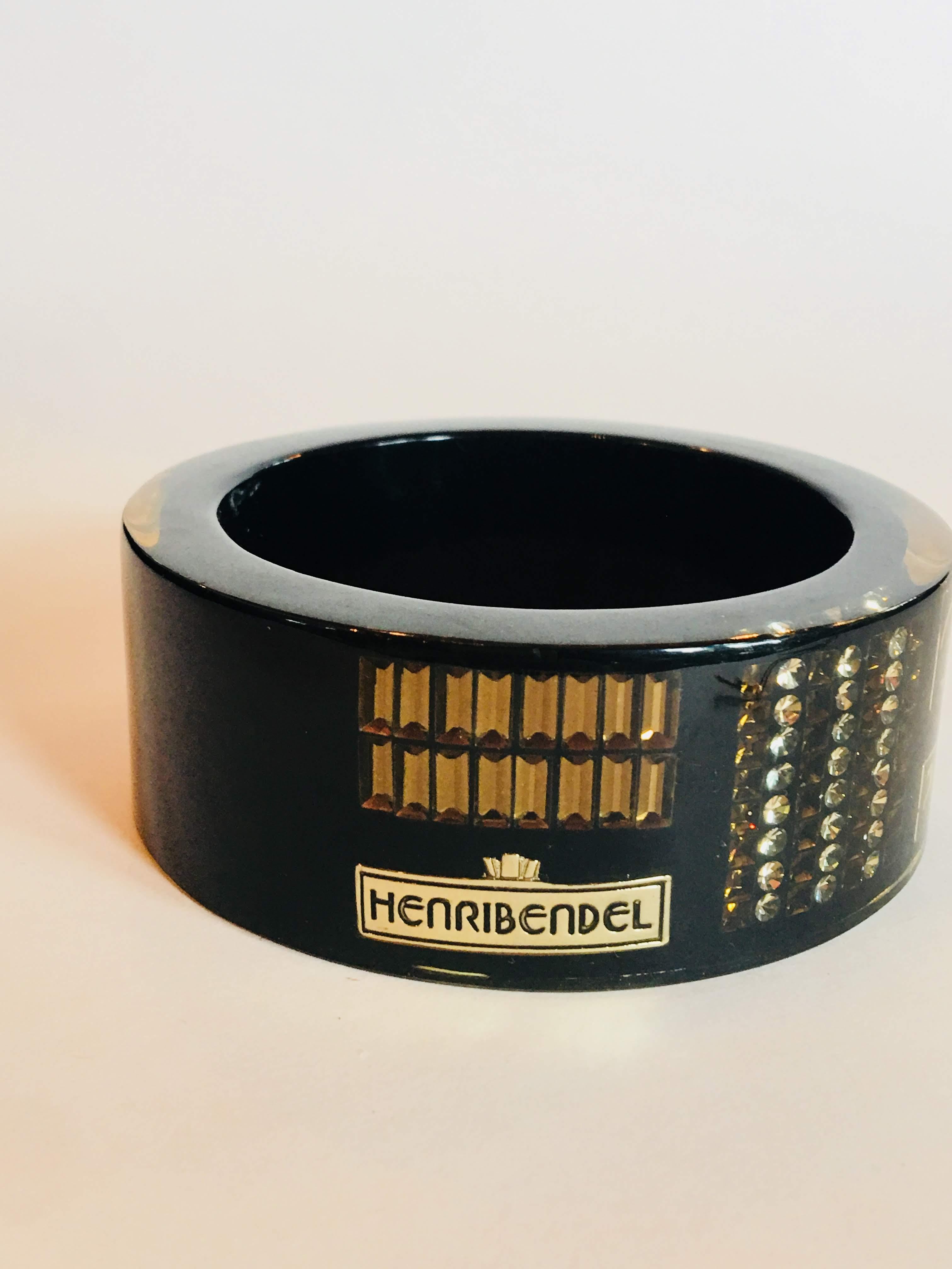 Henri Bendel Black Reisen Bangle with Gold Gems and Silhouette Details and Logo.