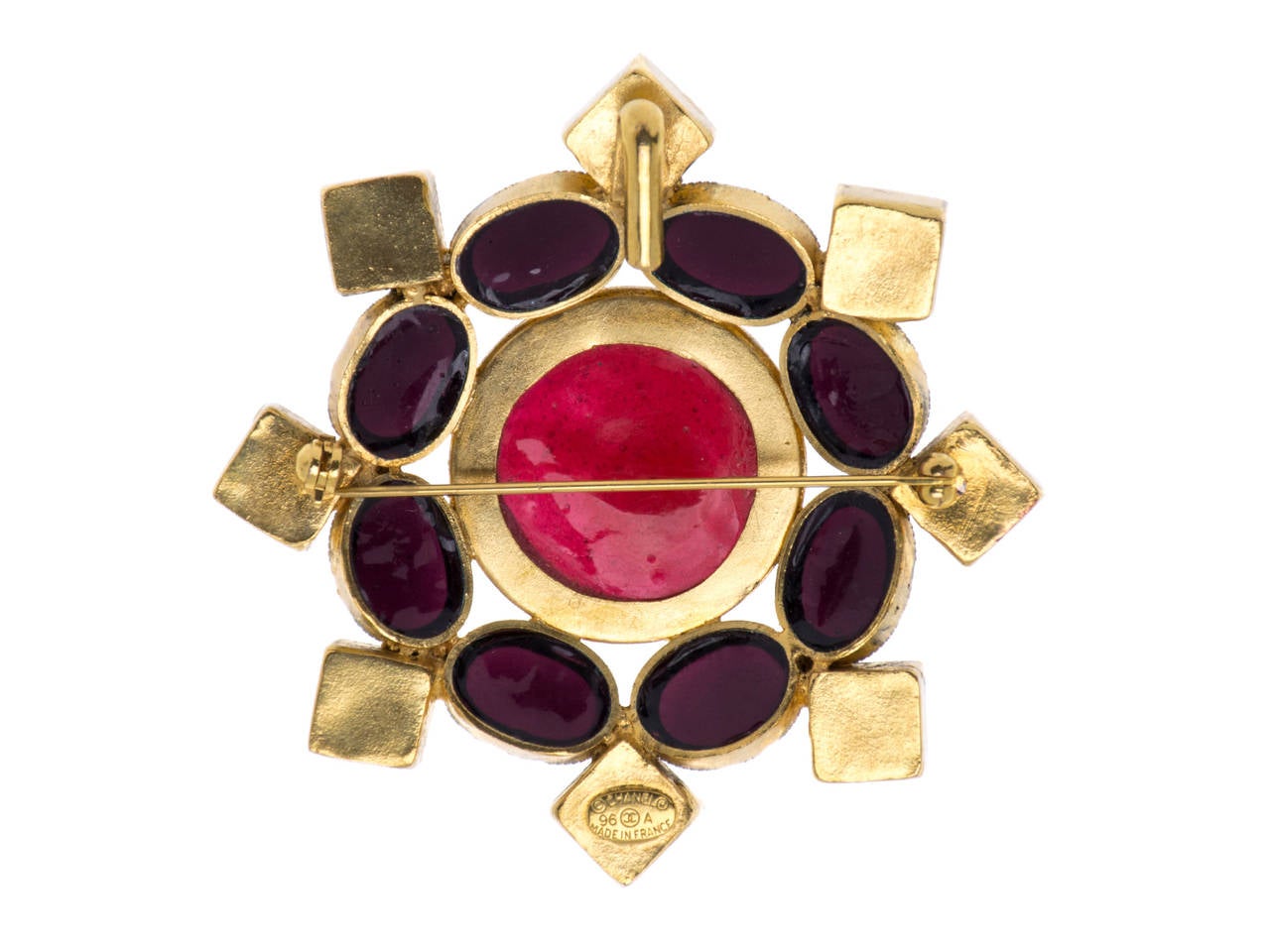 This brooch features a large gold frame accented with large red gripoix glass at the center and square and oval-shaped green and dark purple gripoix pieces around the frame. A 1996 circa. Wear it as a pendant or a brooch.

Measurements: 2