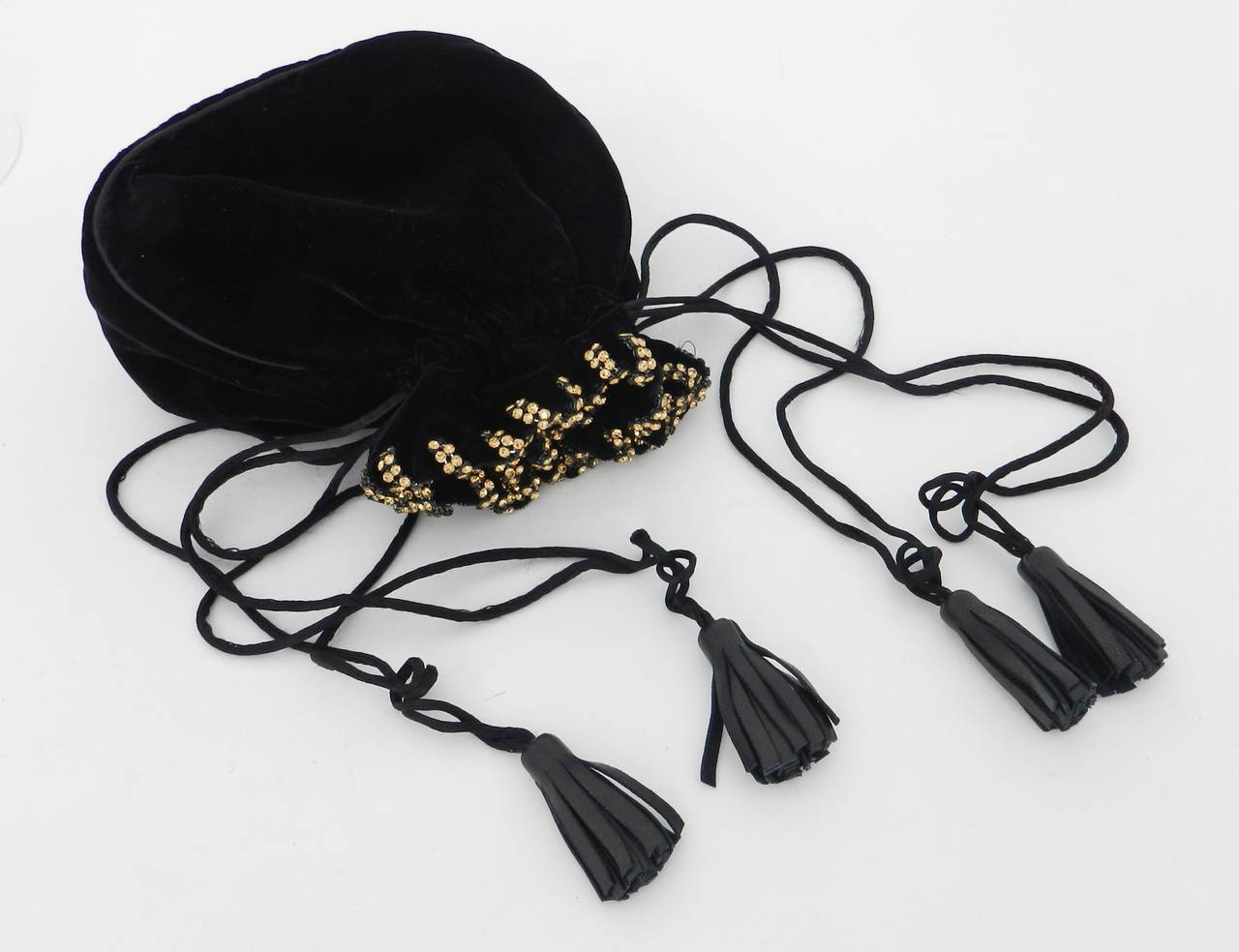 Vintage YSL Yves Saint Laurent black silk velvet evening bag. Drawstring on satin cords with soft lambskin leather tassels and amber rhinestones. Circa 1990's. Body measures about 6.5 x 6.5 x 2.5