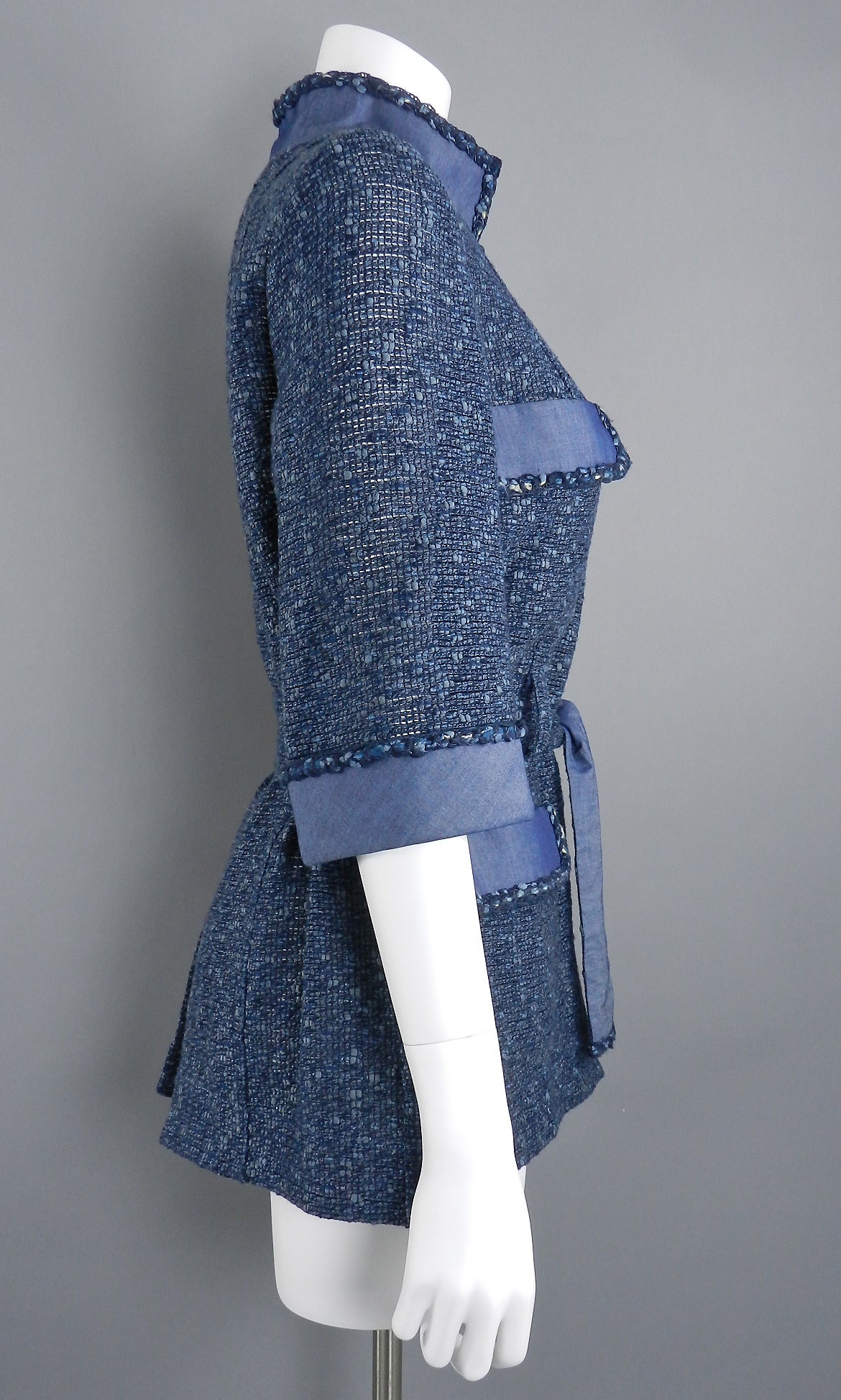 Chanel 2012 Spring denim blue jacket with sash belt. Unlined and unstructured jacket made of 48% cotton, 33 nylon, 14 acrylic, 5 silk. Tagged size FR 38 (USA 6 and can fit an 8). Garment bust is 38