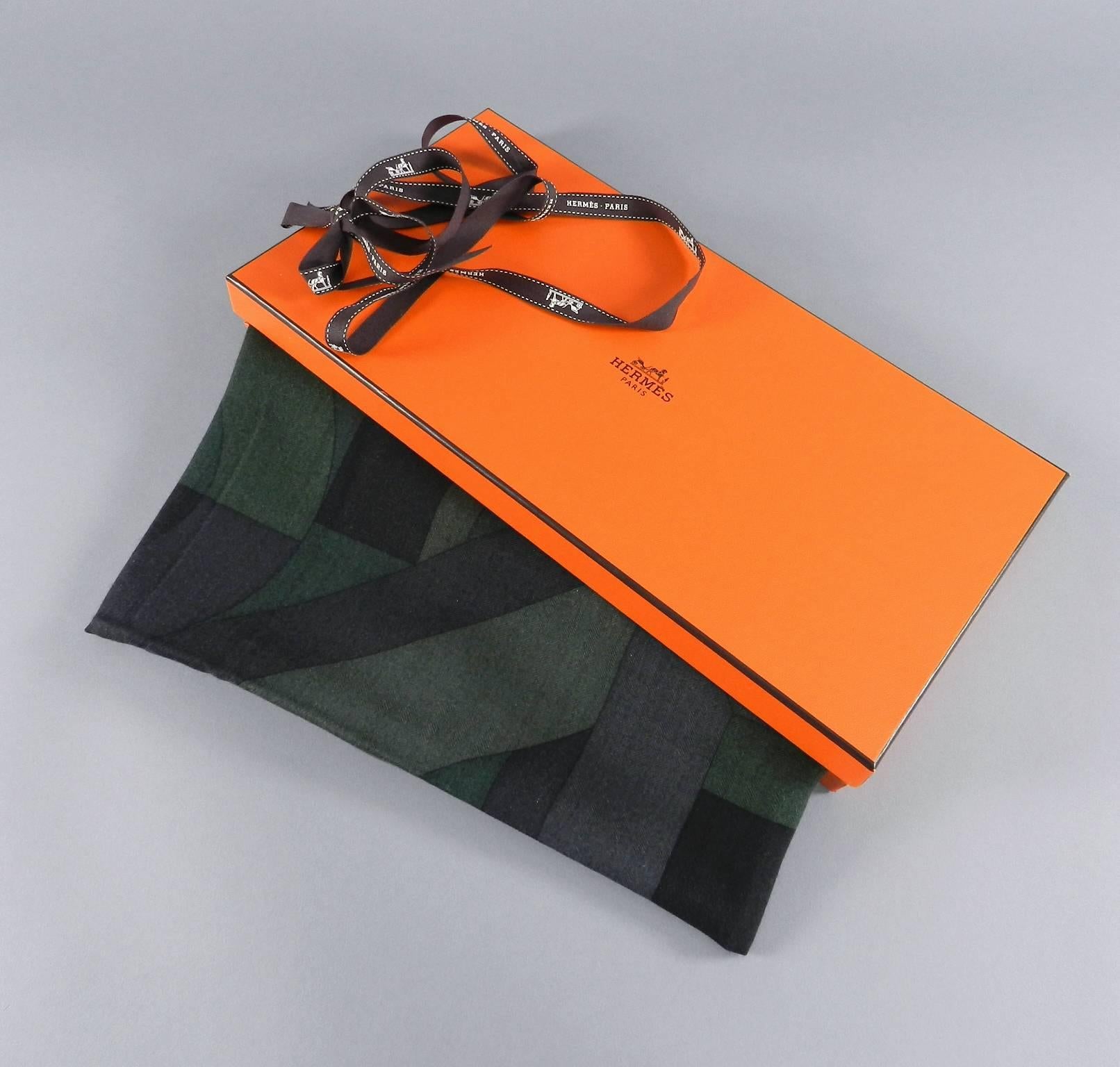 Hermes cashmere and silk scarf 39 x 39”. Perspecitve Cavaliere design in dark forest green tones. Original box and tag attached.  Unworn.

We ship worldwide.
