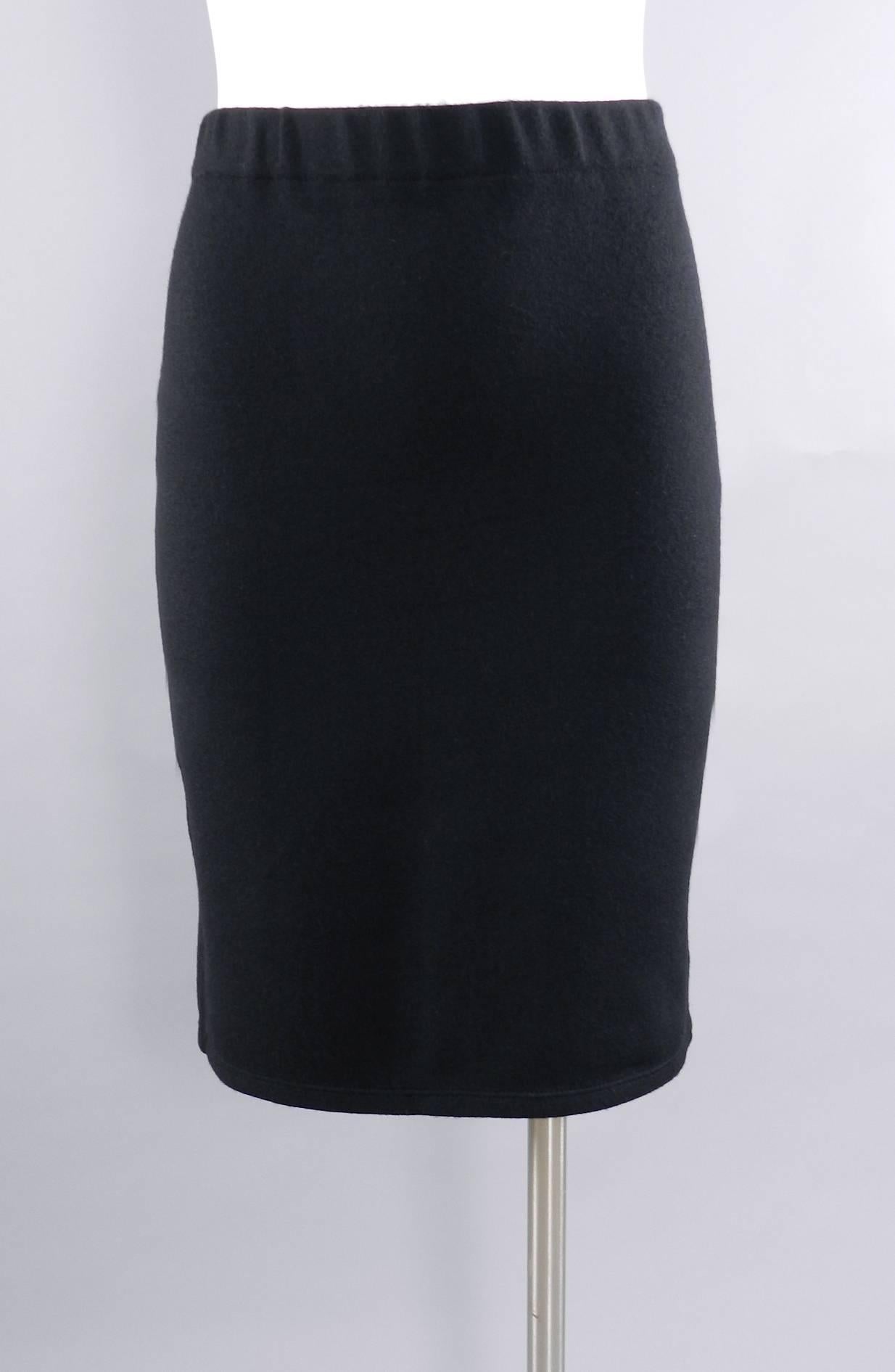 Chanel black knit jersey tube skirt with CC buttons.  Excellent pre-owned condition. Original size tag has been removed but likely a FR 42 (USA 8 or 10). Elastic waistband will fit about 29-32