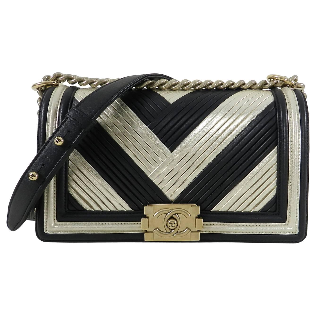 Chanel 16A Le Boy in Rome Medium Black and Gold Chevron Bag.  Limited edition hard to find bag. This medium size bag measures 10”x 6”x 3.25”. Single chain drop 20.5”, double chain drop 11.5”. Excellent pre-owned condition - carried only a few times