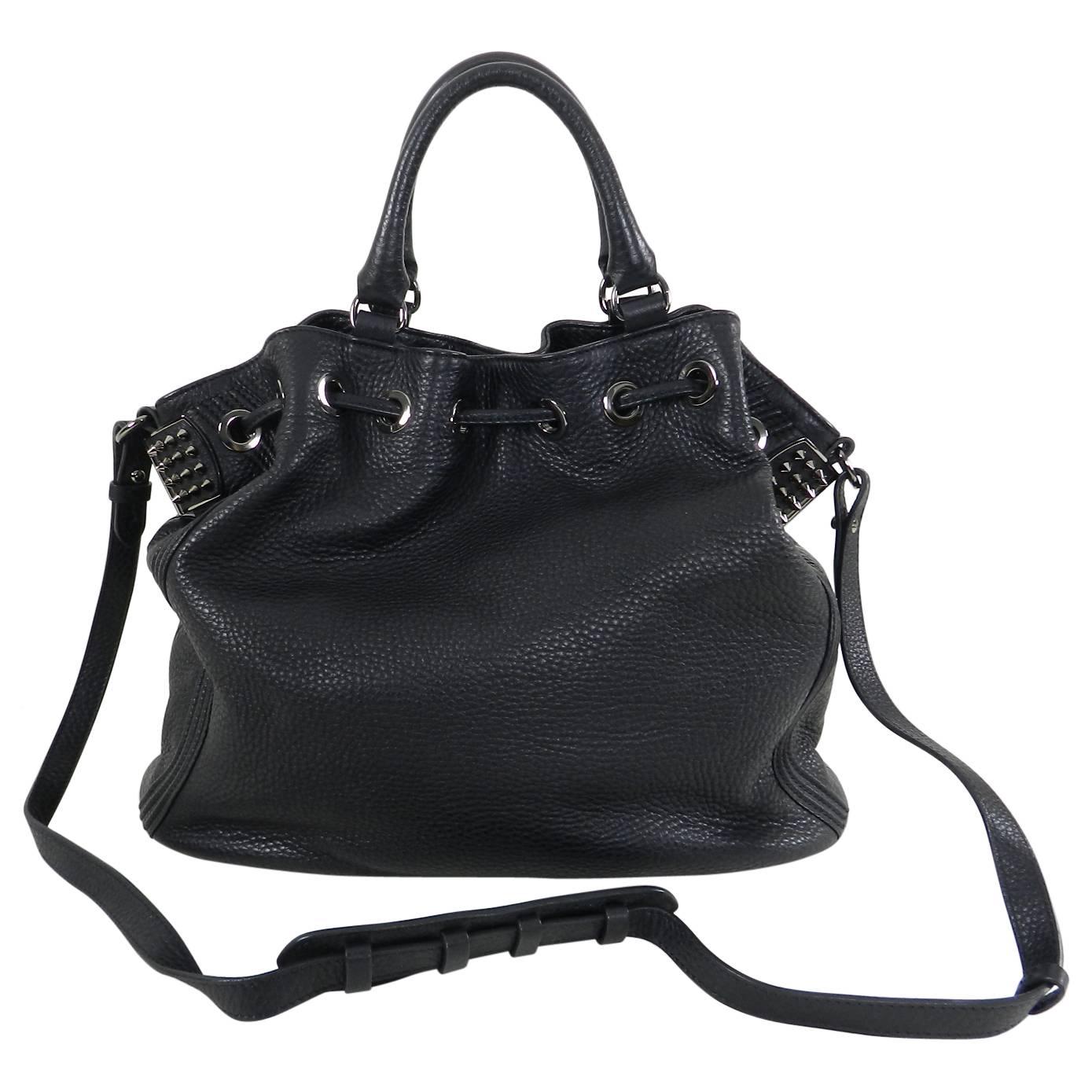Christian Louboutin Black Leather Drawstring Studded Bag. Double handles, long shoulder strap, magnetic interior closure. Handle drop 5.5”. Shoulder strap drop 17.5”. Body of bag measures about 17.5”x 12.5”x 7.25”. Excellent pre-owned condition.