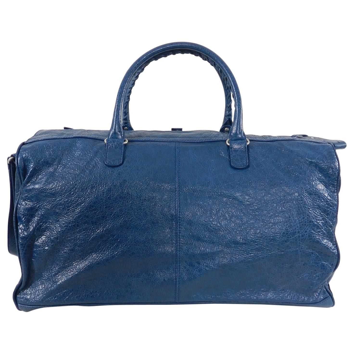 Balenciaga City Blue Giant Weekender Overnight Duffle Bag.  Blue leather bag with silvertone hardware and studs.  Double braided handles, long shoulder strap, roomy interior.  Excellent clean pre-owned condition with no significant wear to note. The