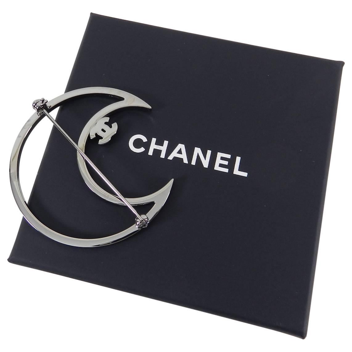 Chanel 2017 Cruise Blue Rhinestone Ruthenium Crystal CC Moon Brooch.  Light blue rhinestones with CC logo and moon design.  Brand new unworn in box. 2-1/8” x 2-1/8”
