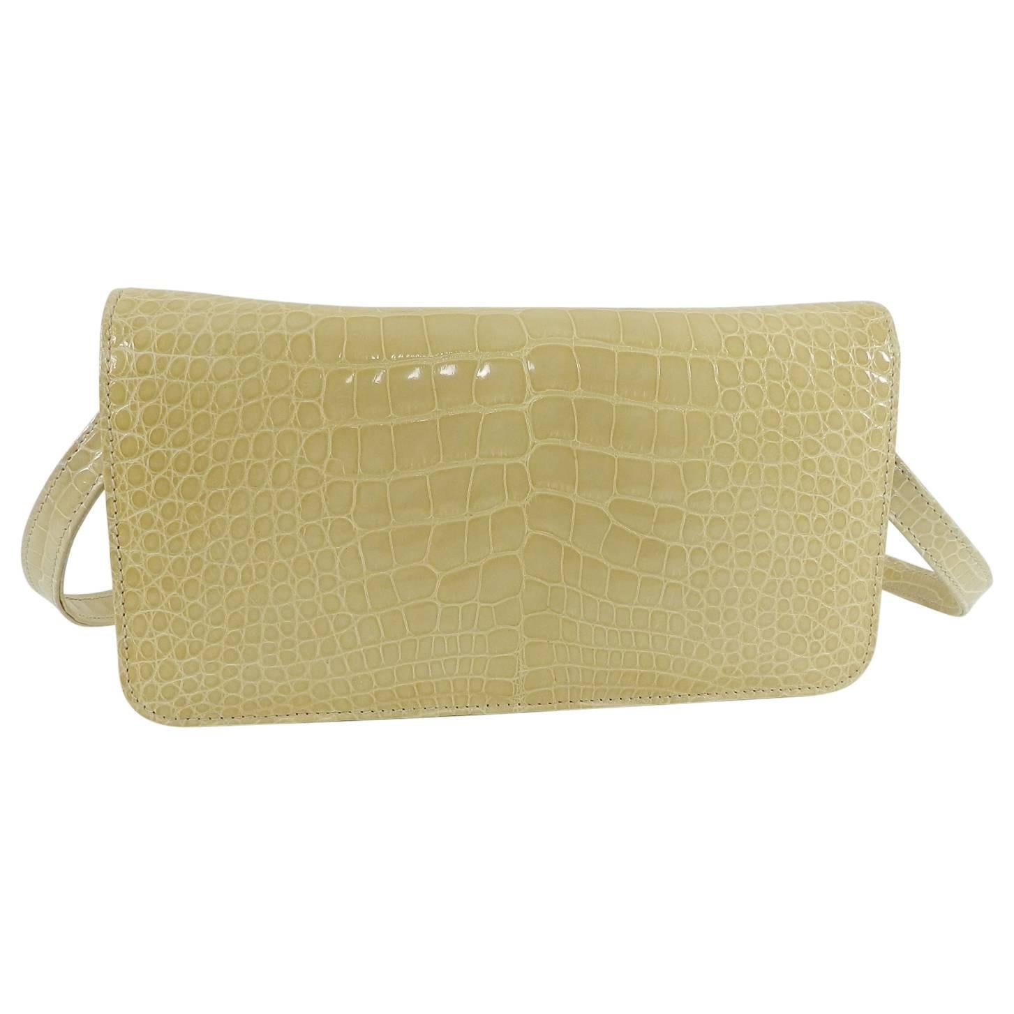 Manolo Blahnik Buttermilk Crocodile Clutch Bag with Strap.  Glossy light buttermilk yellow crocodile skin bag with removable shoulder strap.  Leather lined interior.  Measures 9.25 x 5.25 x 2” with 13.5” strap drop.
