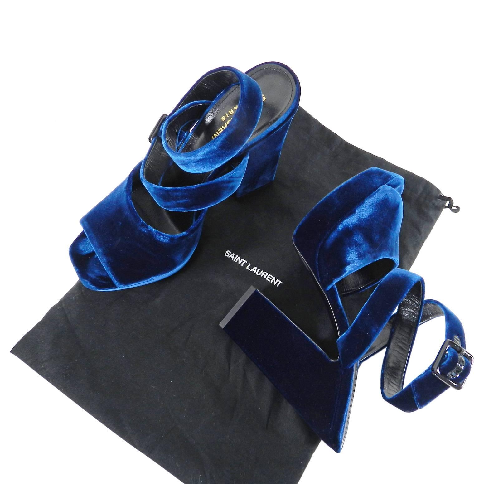 Saint Laurent Blue Velvet Debbie Platform Sandals.  Midnight blue soft velvet with thick structured heel and wrap-around ankle strap accented with black patent leather trimmed buckle. 5” heel. Marked size 39 ½ (USA 9). Original price $995 USD.