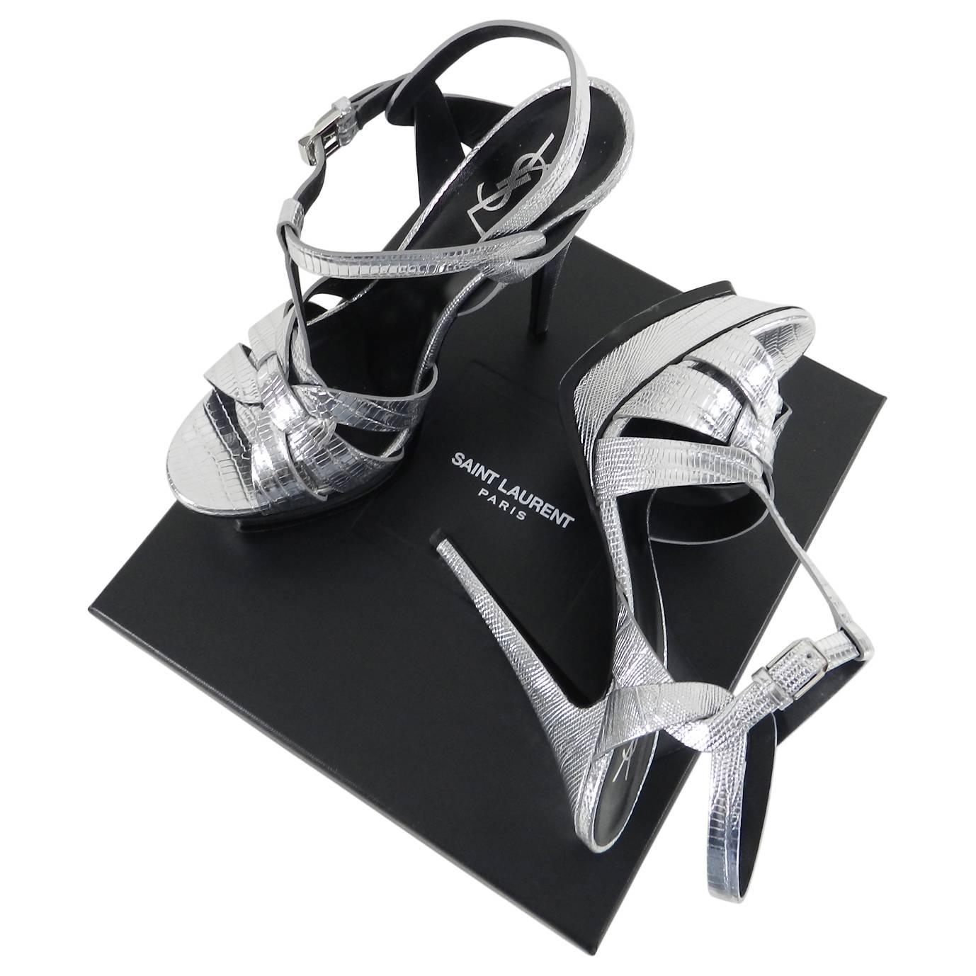 Saint Laurent Silver Metallic Tribute Faux Lizard Embossed Sandals.  Pointed stiletto heel, platform base, adjustable ankle strap with silver toned buckle. Marked size 40 (USA 9.5). 135mm high heel.  Excellent pre-owned condition with some light