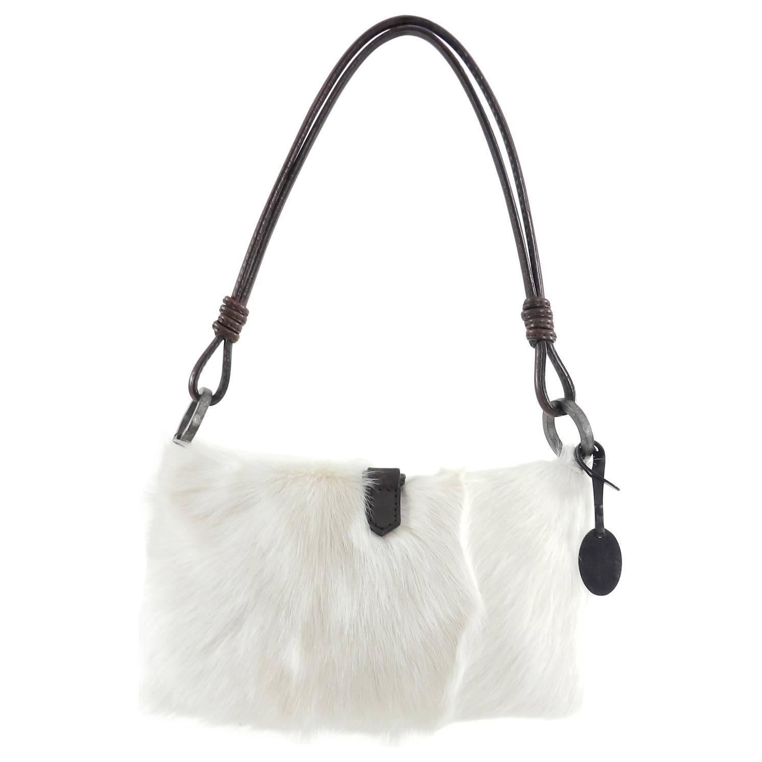 Valentino White fur Bag with Suede Flowers.  Soft white goat fur body lined in burgundy satin fabric.  Bag has a fold over design and stays closed with the weighted metal V logo charm.  Dark brown leather trim.  Excellent pre-owned condition with