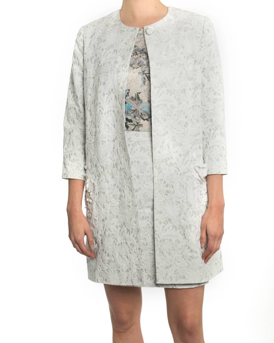 Erdem guipure lace cocktail coat.  Color is the palest grey / white with a hint of blue. Fastens at top front neck with one button, side hip pockets on seam, lace floral and bead detail on pockets.  Interior is lined with blue floral silk