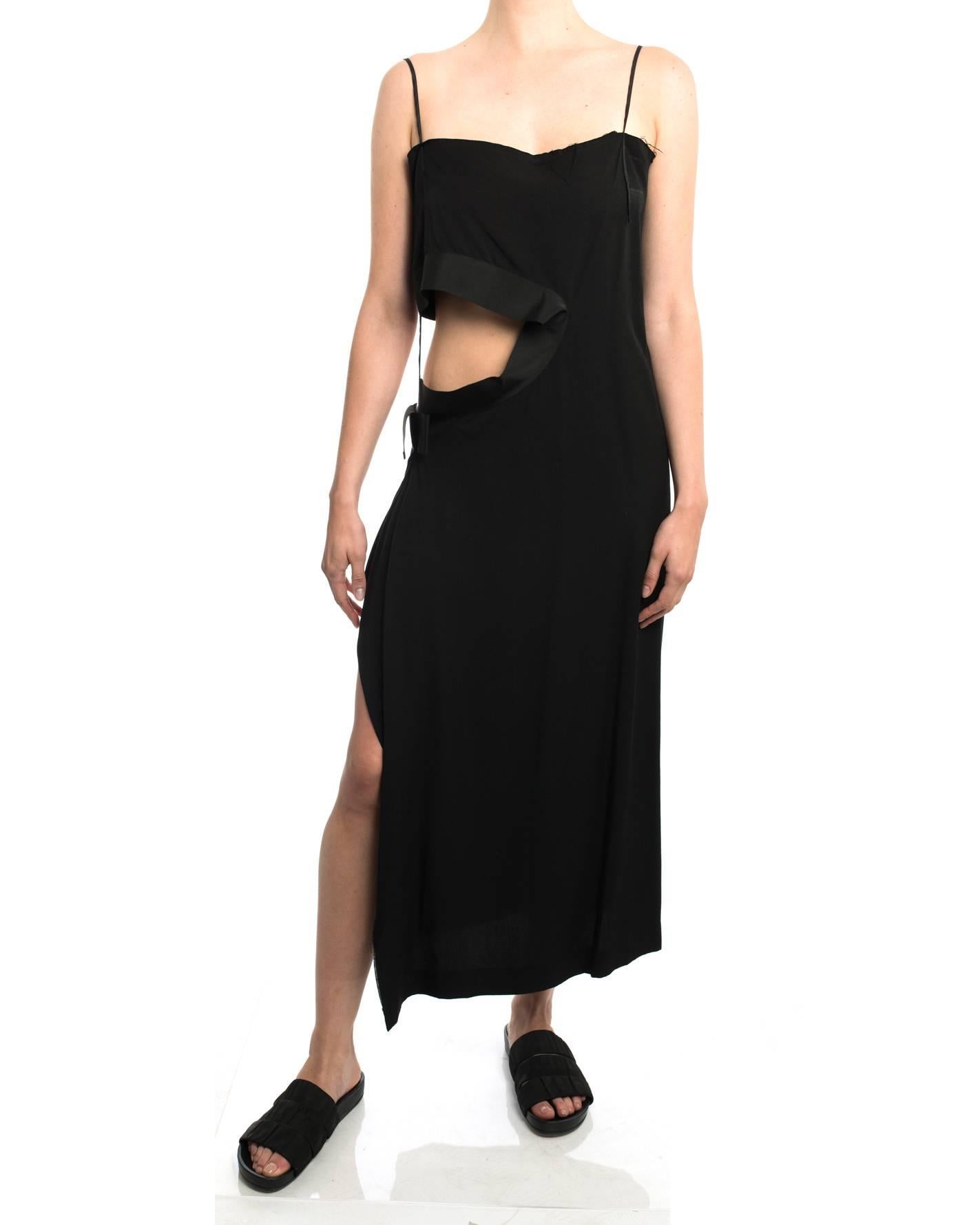 Yohji Yamamoto Spring 2004 black cut-out waist dress. Straight- cut column design with shoulder straps. Cut-out at left side is trimmed with wide grosgrain ribbon. Pull-over design with no zippers or closures. Tagged size Yohji 1 - best for about