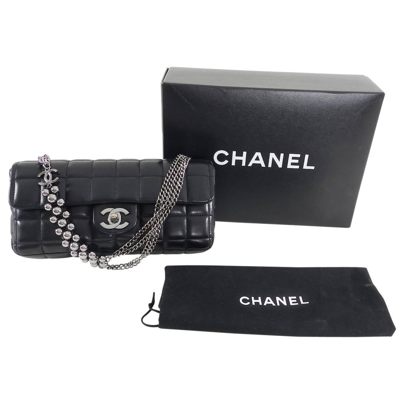 Chanel Chocolate Bar Black Leather Flap Bag with Silver Bead Chain.  Smooth black lambskin leather with silvertone metal CC turn clasp and beaded chain strap.  Black fabric logo lined interior.  Date code series 10 for production year 2006. 