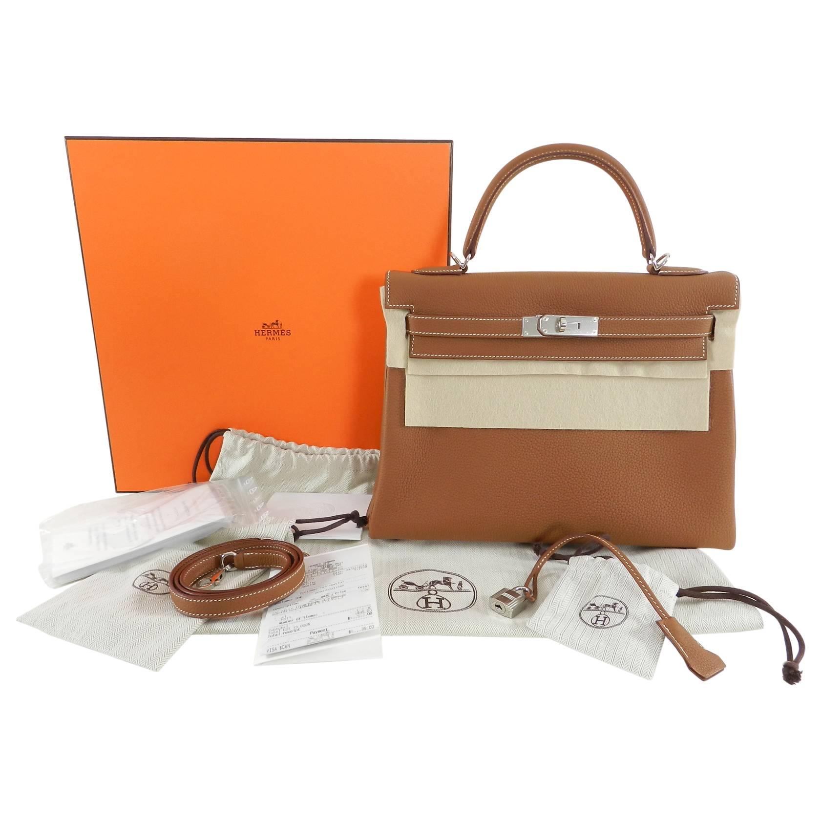 Hermes Kelly II Retourne 32cm in Gold color and Togo leather.  Ivory topstitching and palladium Hardware. Brand new in box. Has been un-packaged but not carried.  Plastic still on metal. Fully outfitted with duster, strap duster, clochette duster,