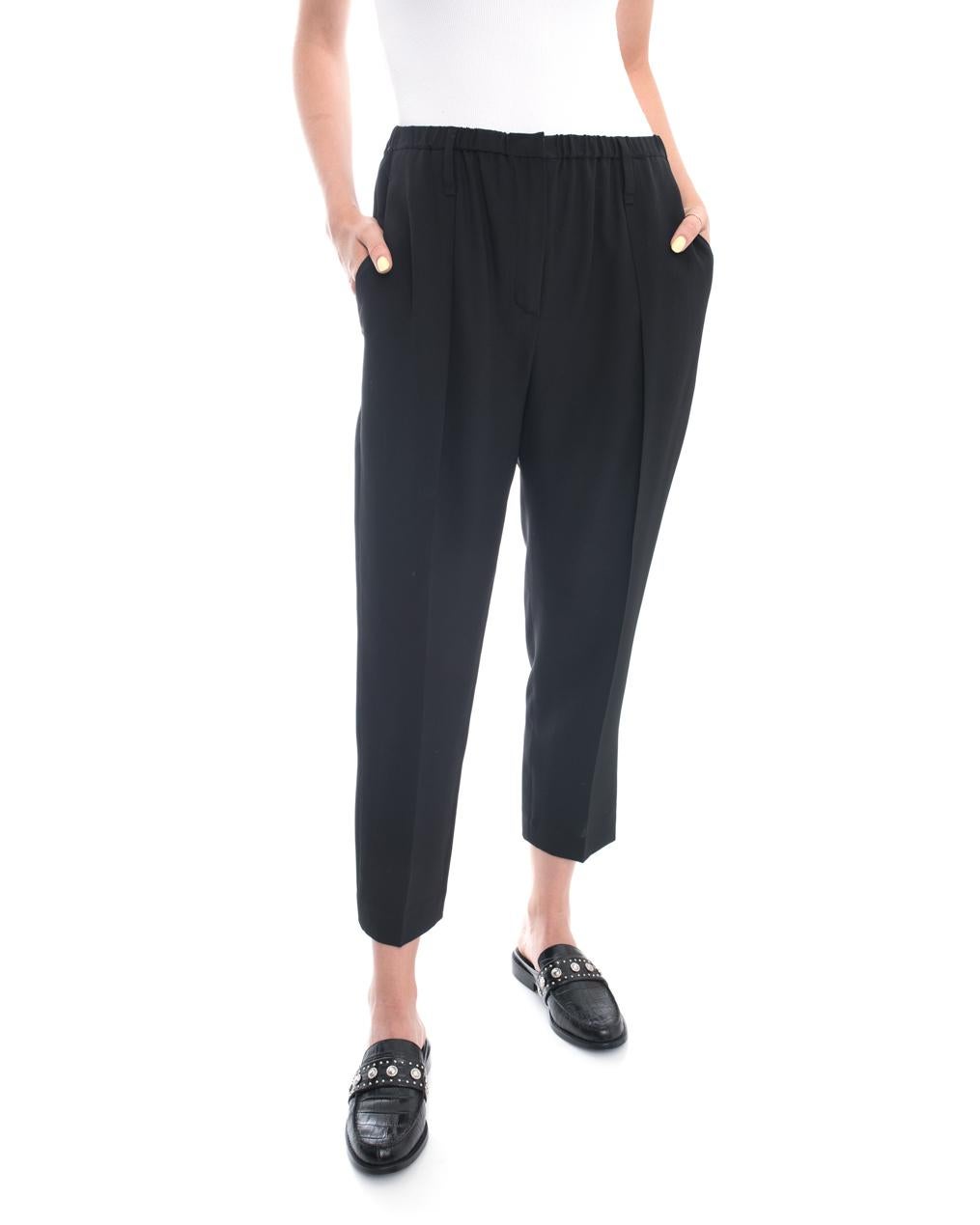 Brunello Cucinelli black silk Pleated Trousers. Elastic waist, side hip pockets, tapered cropped design, pleated at waist.  Marked size IT42 (USA 6).  Measures 28-30” elastic waist, 41” hip designed to be worn by about 37” hip for ease of movement,