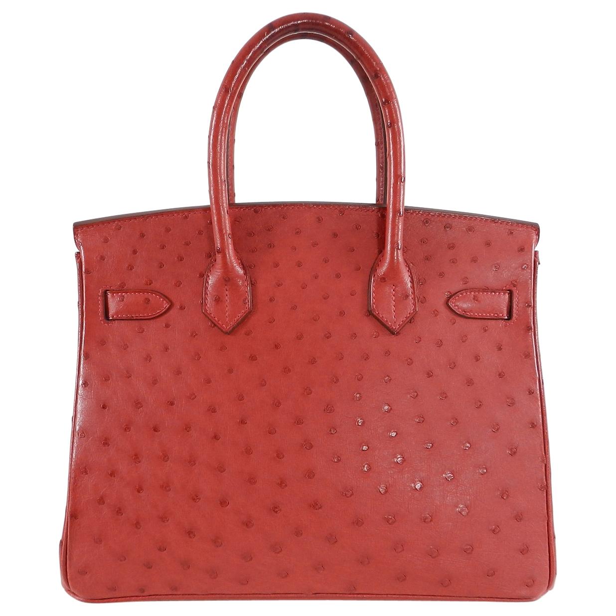 Hermes exotic skin ostrich birkin in rouge vif.  Goldtone metal hardware, tonal stitching, double rolled handles, front toggle closure. Includes lock, clochette, two keys, duster, clochette duster, original sales receipt, Certificate of Origin