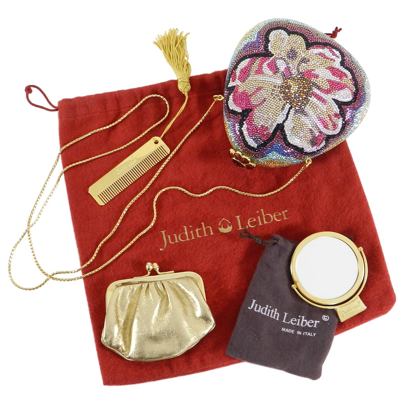 Judith Leiber Flower Jewelled Strass Minaudiere Evening Bag.  Enamel flower push clasp opening, gold leather lined interior, long gold metal chain strap.  Includes signature comb, mirror, and coin pouch.  Duster included.  Measures 5 x 4.75 x 1.75”.