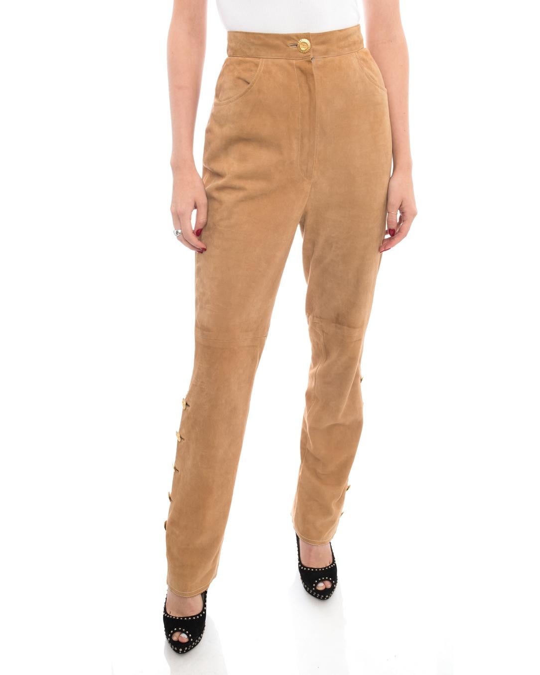 Chanel Vintage 1980’s Tan High Waisted Suede Pants.  Gold anchor buttons decorate the bottom cuffs, extra high waisted design, soft lambskin suede.  Lined with CC logo jacquard fabric. Size tag has been removed but is a USA 6. Measures 27” at high