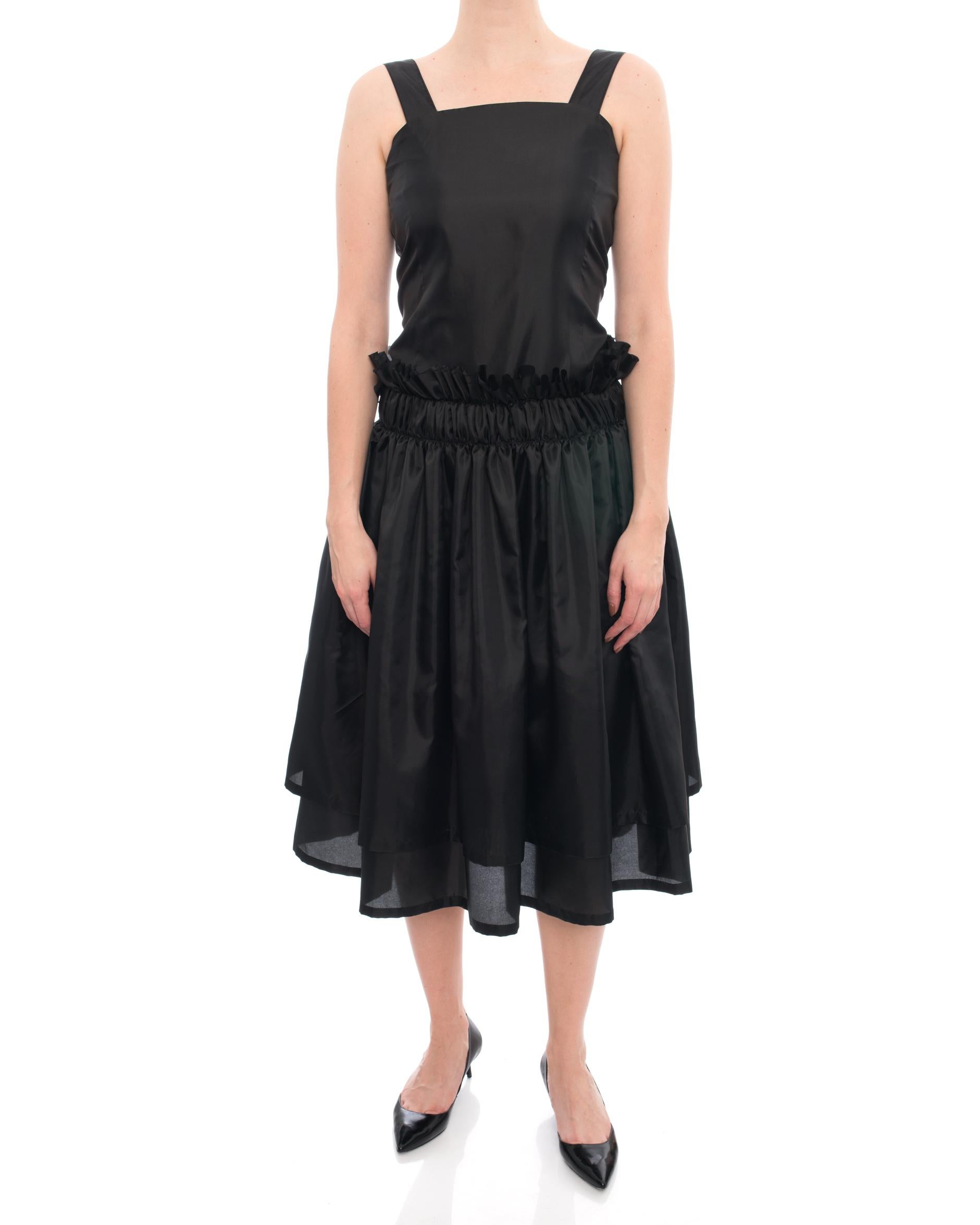 Noir Kei Ninomiya Comme Des Garcons Black Ruffle Dress.  Midi length,  double layered skirt,  ruffle drop waist,  side pockets on seam.  Marked size S (USA 6).  To fit 33” at bust, straight cut dropped waist for about 26-27”, full hip.  Armpit to