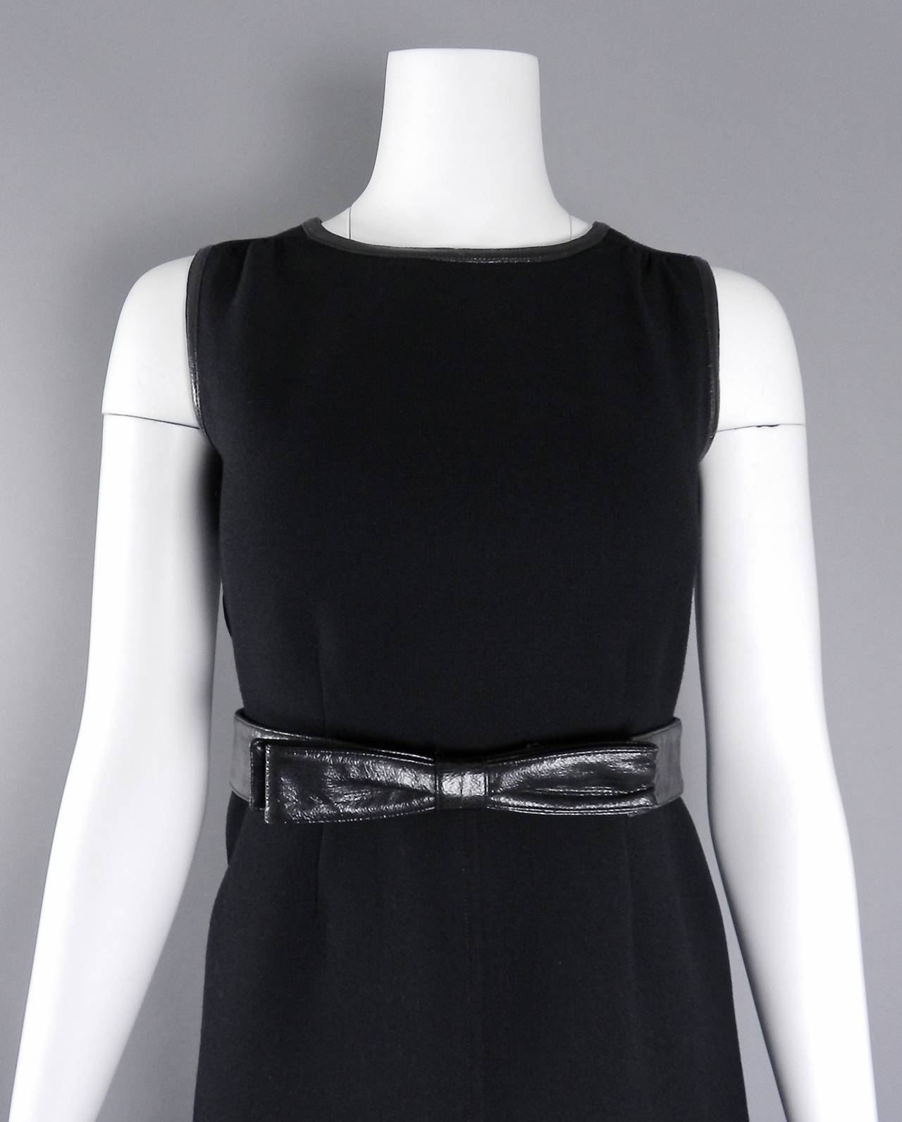 Vintage 1960's Courreges black wool gown with vinyl trim. Centre metal back zipper, lined with white fabric, medium to thick wool. Excellent vintage condition but vinyl trim around armholes shows minor wear appropriate with age. Garment has small