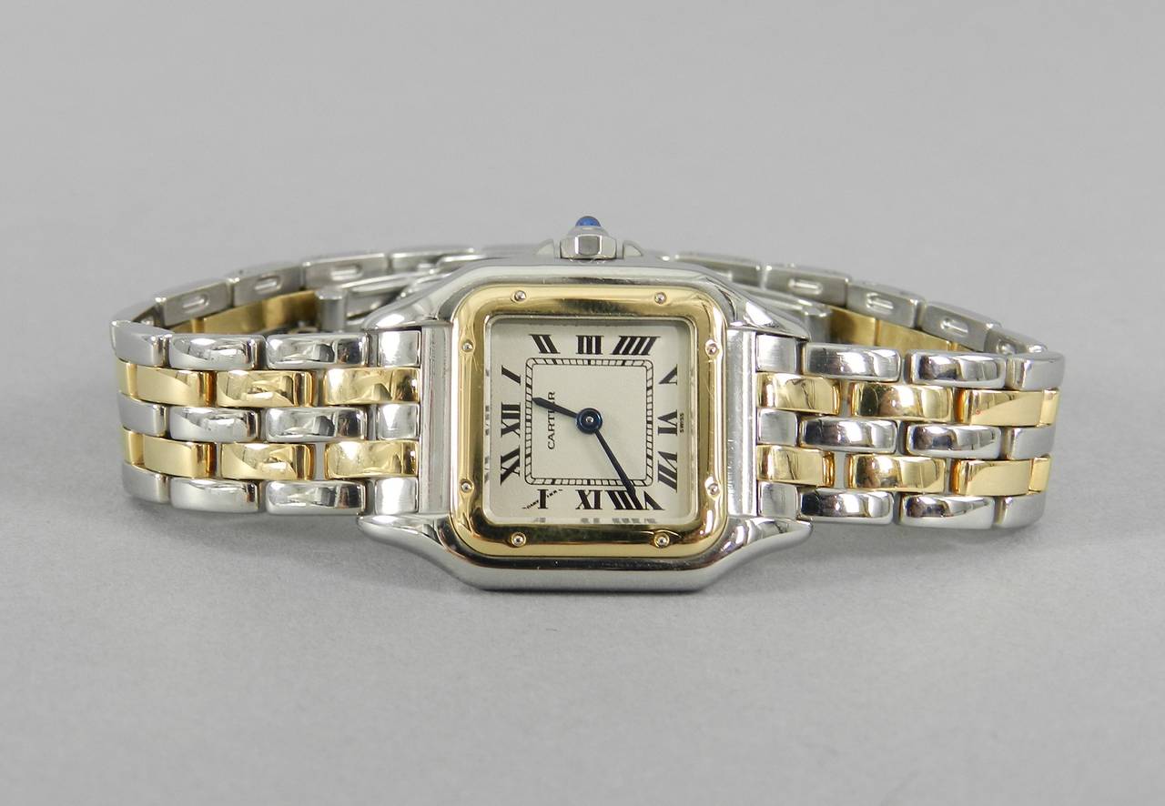 Cartier Panthere ladies small 2 row 18k gold and stainless watch. Excellent previously owned condition. Discontinued model (#1120). Sapphire cabochon on turn, roman numerals, quartz movement. This watch does not have extra links or original box and
