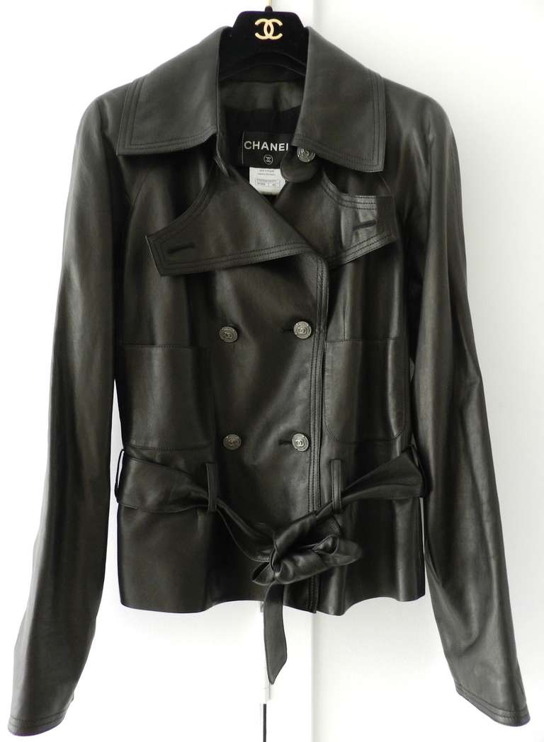 Chanel 2012 resort runway collection black leather short jacket. Softest lambskin leather jacket lined in 100% silk. Light-weight for Spring. Sash belt, double row of buttons, front pockets, raglan sleeves.  Excellent condition - worn a few times.