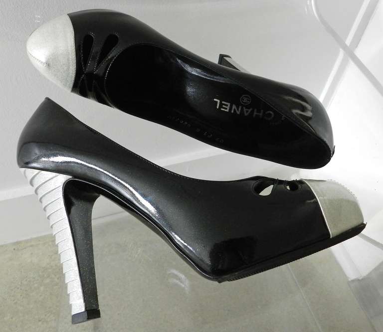 Chanel black and white high heels. Black patent leather, white patent with silver glitter sparkles. Size 41. Unworn but has had rubberized grips added to sole. Heel is 4 5/8