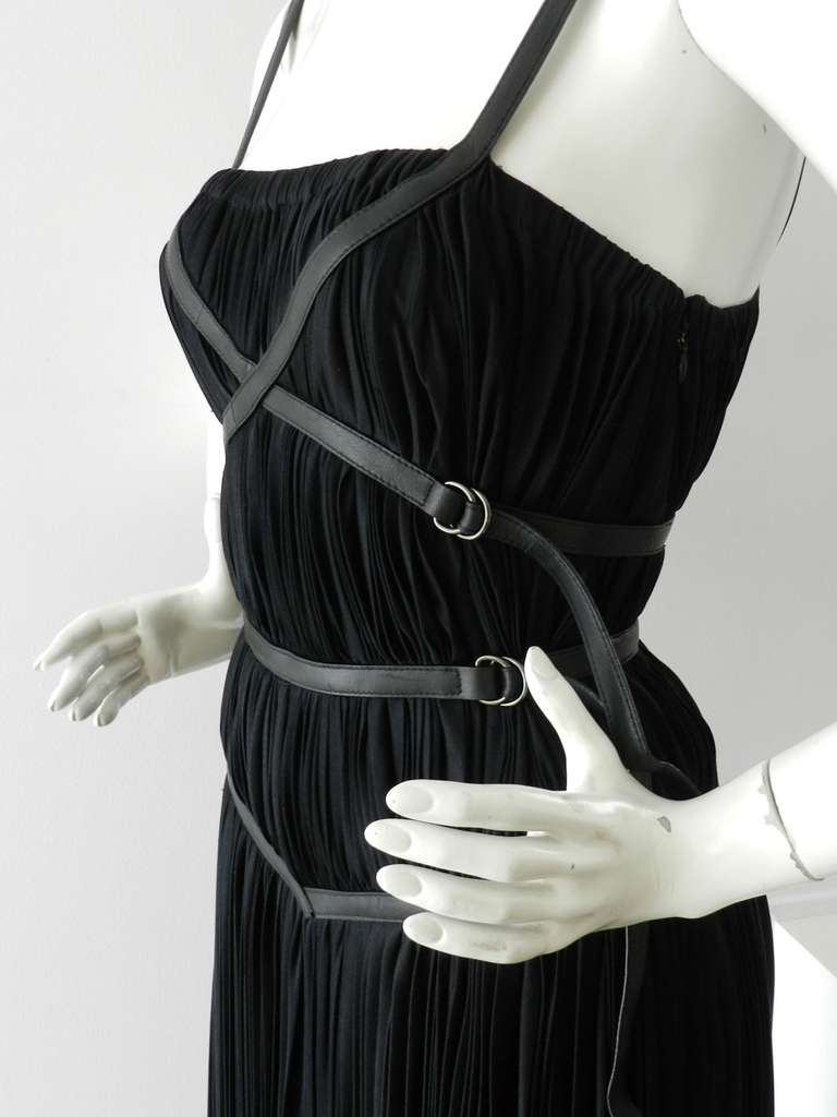 Prada black pleated strappy dress with leather trim. 100% silk jersey flowing body and leather straps. Asymmetrical hemline, hidden side zipper, vertical pleats. Tagged size IT 38 (USA 2). 

Shipping prices provided are for FedEx Ground to the